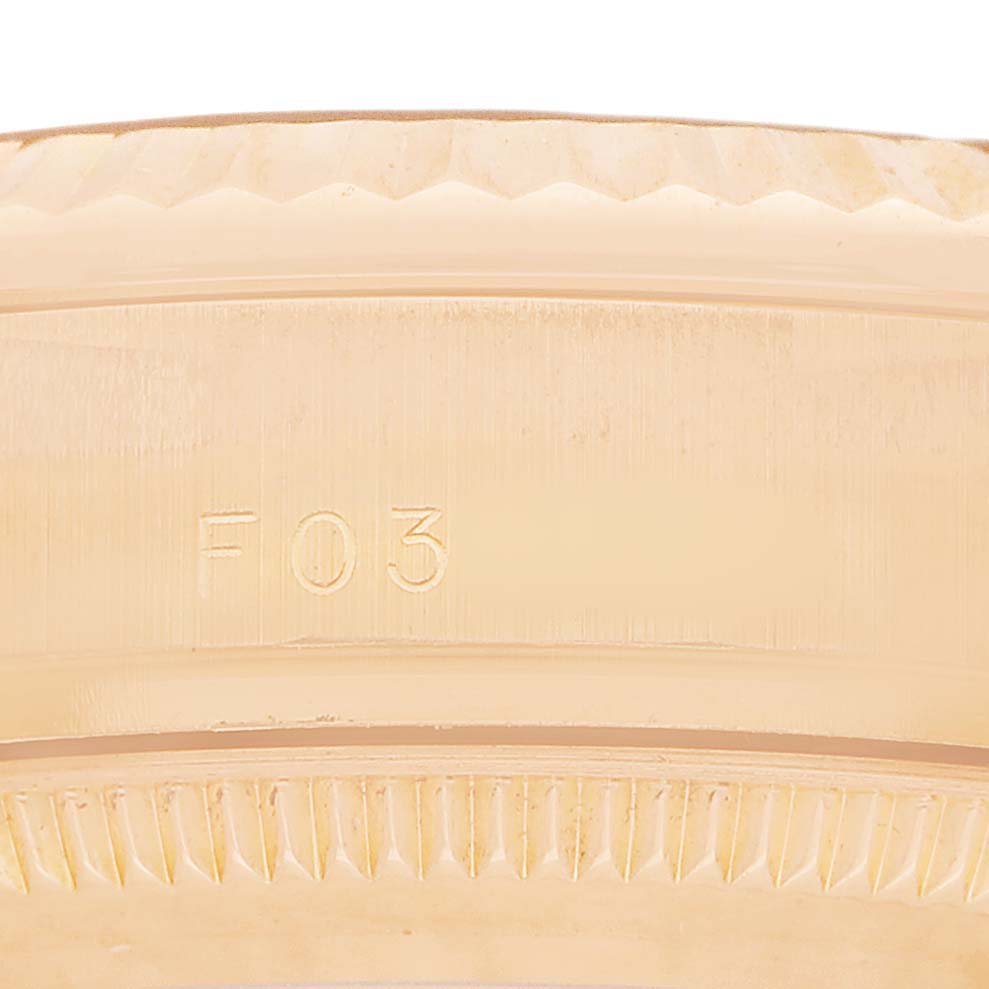 The image shows a close-up of the edge and engraving on a Rolex President 178275 Women's Rose Gold Pink Dial watch bezel.