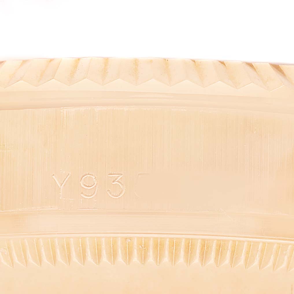 The image shows a close-up of the serial number area on the Rolex President 178275 Women's Rose Gold Black Dial model case with distinct edge detailing.