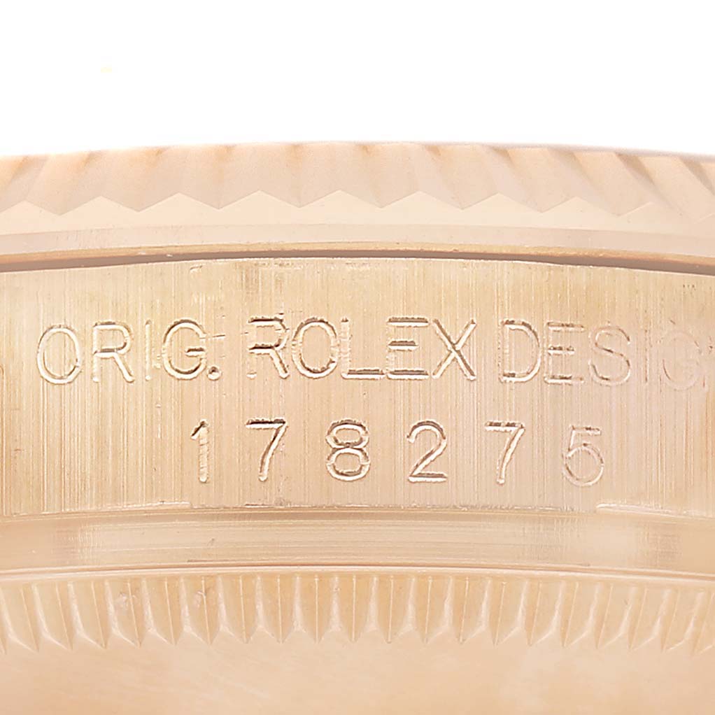The image shows the engraved case side of a Rolex President 178275 Women's Rose Gold Black Dial model, highlighting the model number and design details.