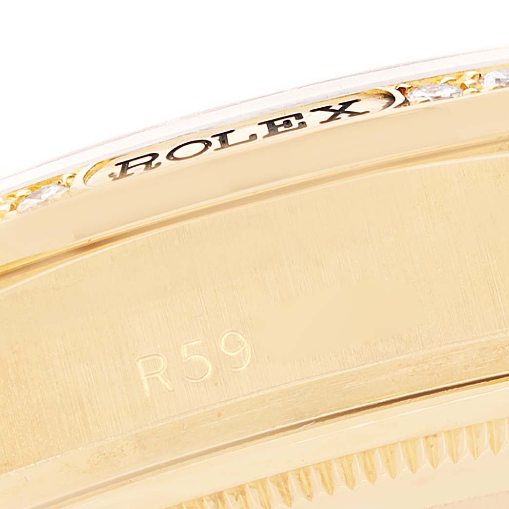 This close-up angle shows the side of the Rolex President 18138 Men
s Yellow Gold Champagne Dial 18138 Men
s Yellow Gold Champagne Dial model, highlighting the engraved "ROLEX" and part of the bezel with diamonds.