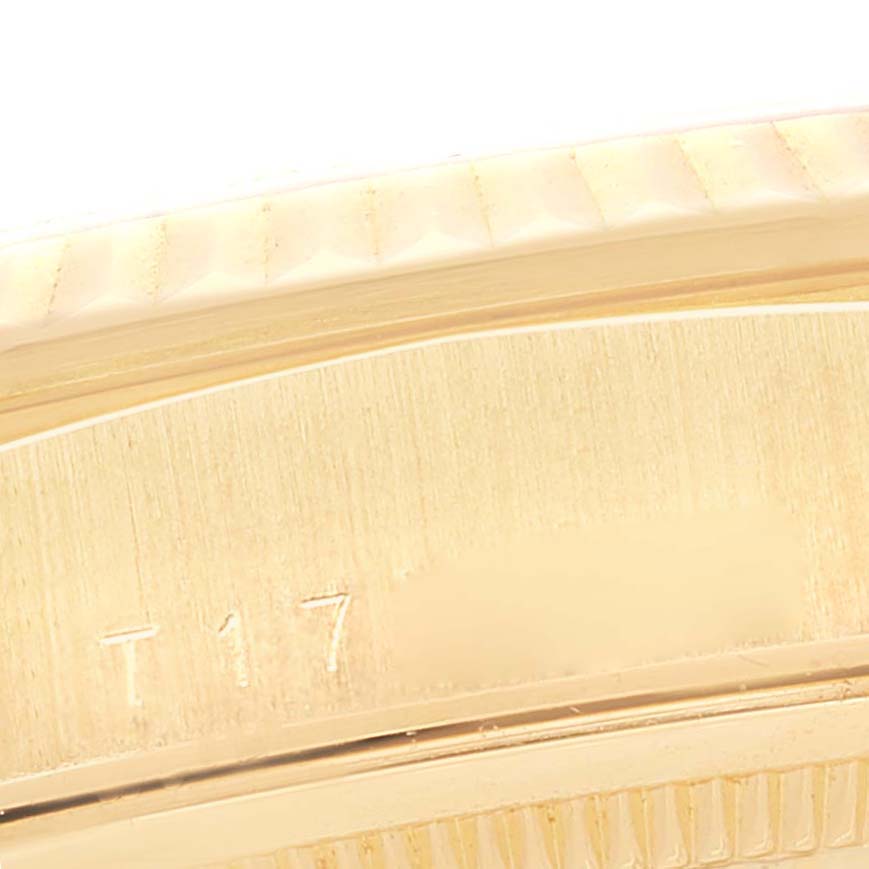 This close-up image shows a portion of the gold bezel and case edge of a Rolex President 18238 Men
s Yellow Gold Champagne Dial 18238 Men
s Yellow Gold Champagne Dial model watch.