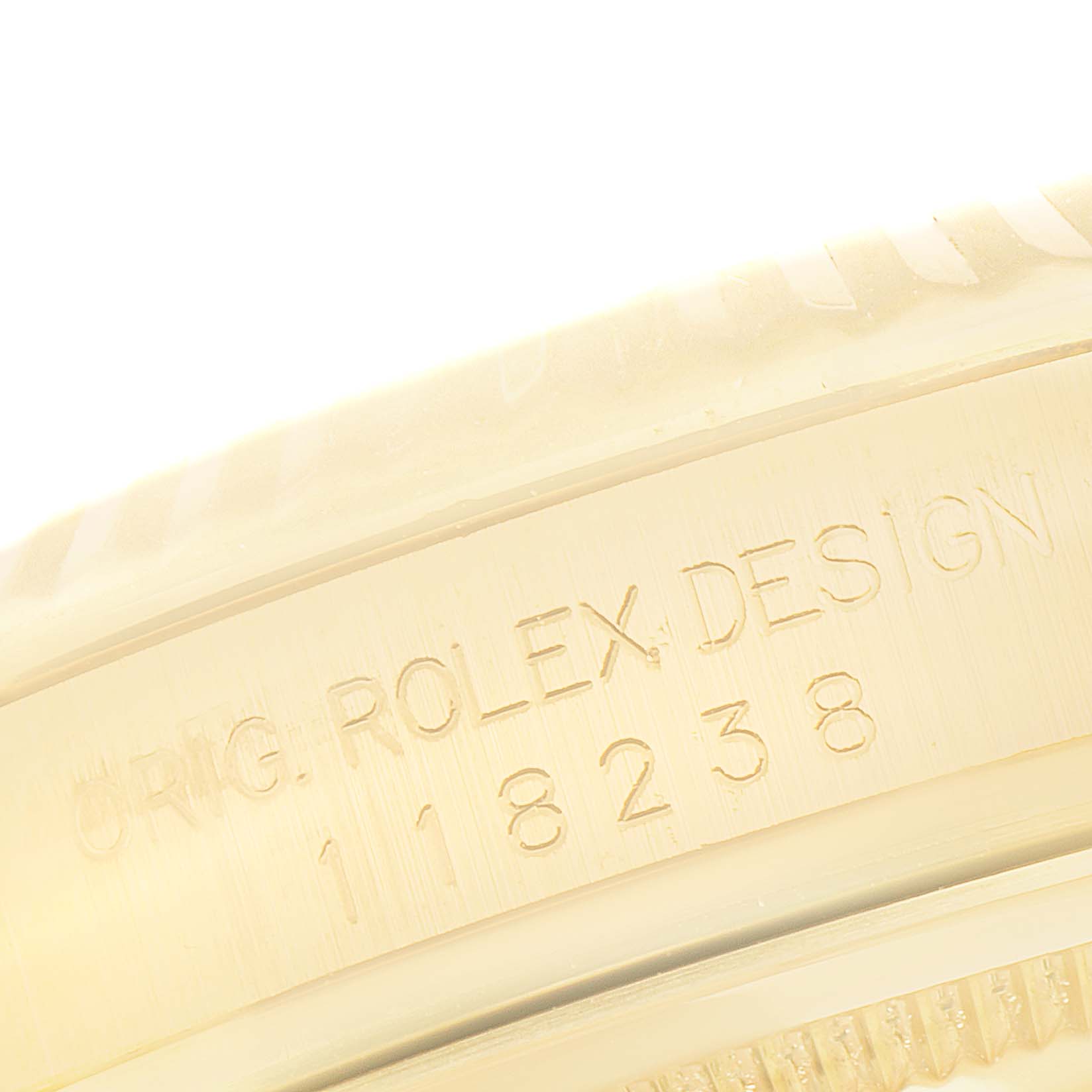 The image shows the engraved side of the Rolex President 118238 Men's Yellow Gold Champagne Dial model, featuring "ORIG. ROLEX DESIGN" and the model number.