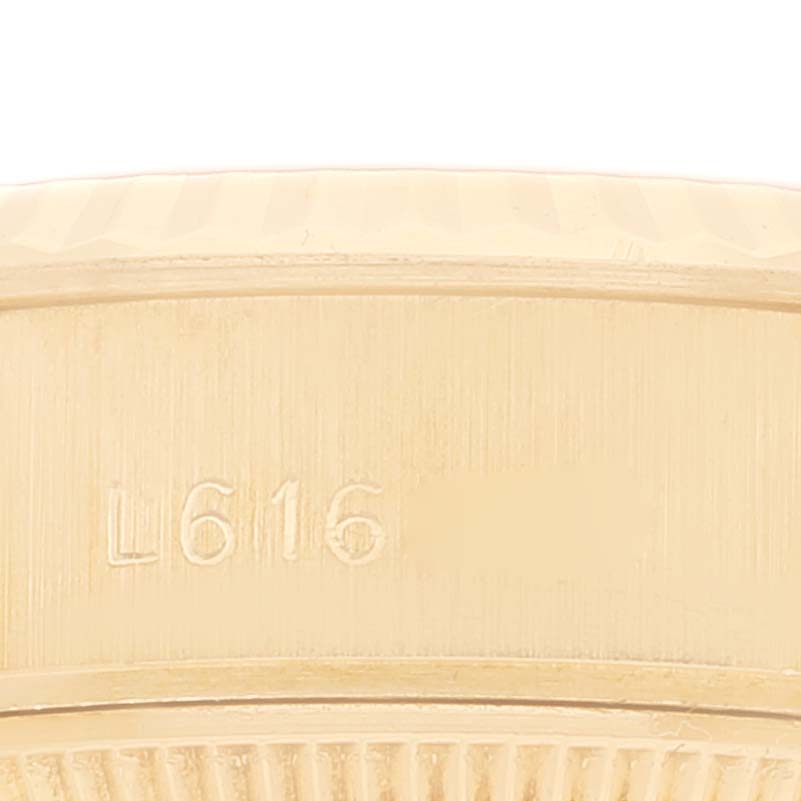 This image shows a close-up of the case edge with engravings on a Rolex President 69178 Women
s Yellow Gold Champagne Dial 69178 Women
s Yellow Gold Champagne Dial model.