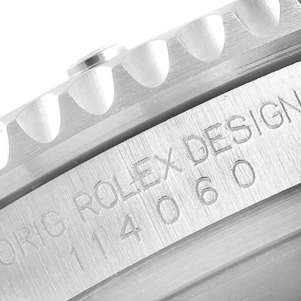 The image shows a close-up of the side engraving and bezel of a Rolex Submariner 114060 Men
s Stainless Steel Black Dial 114060 Men
s Stainless Steel Black Dial watch.