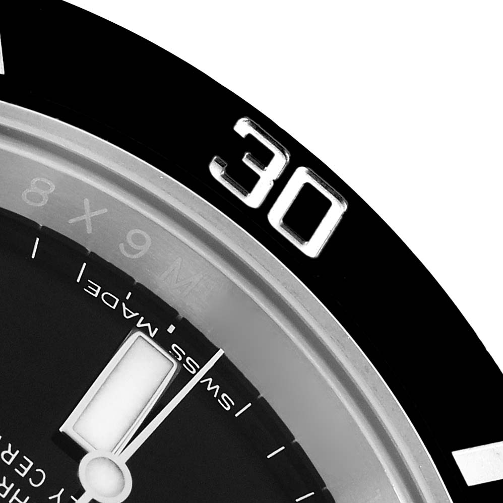 The image shows a close-up of the Rolex Submariner 116610 Men
s Stainless Steel Black Dial
s bezel and dial partially, highlighting the 30-minute mark.