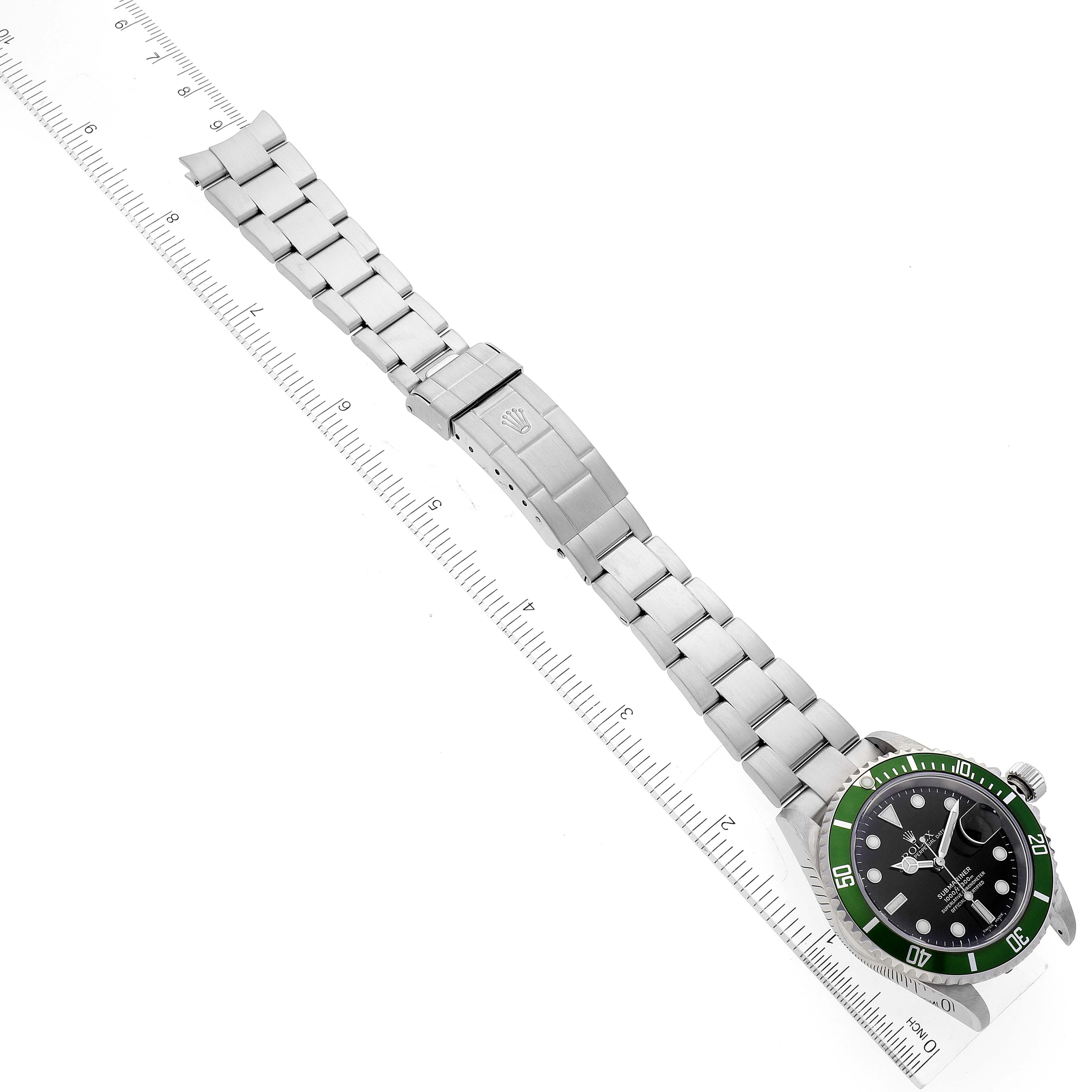 The image shows a top-down view of a Rolex Submariner 16610LV Men
s Stainless Steel Black Dial 16610LV Men
s Stainless Steel Black Dial watch with its full bracelet extended and placed alongside a ruler for scale.