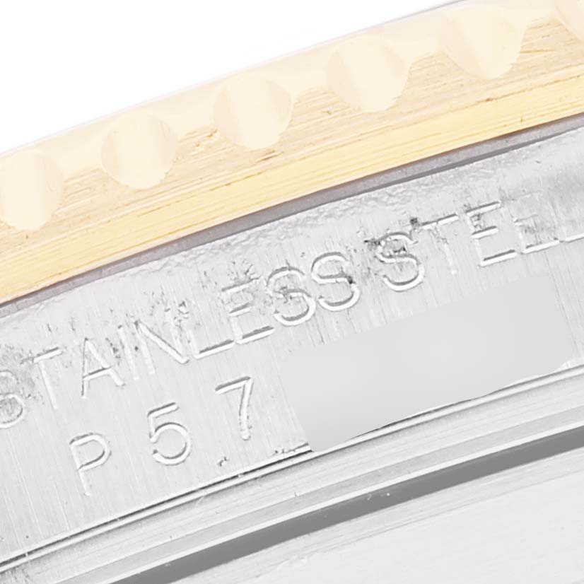 The image shows a close-up of the side of a Rolex Submariner 16613 Men's Steel and Gold (two tone) Black Dial 16613 Men's Steel and Gold (two tone) Black Dial watch, highlighting a portion of the bezel and engraved markings.