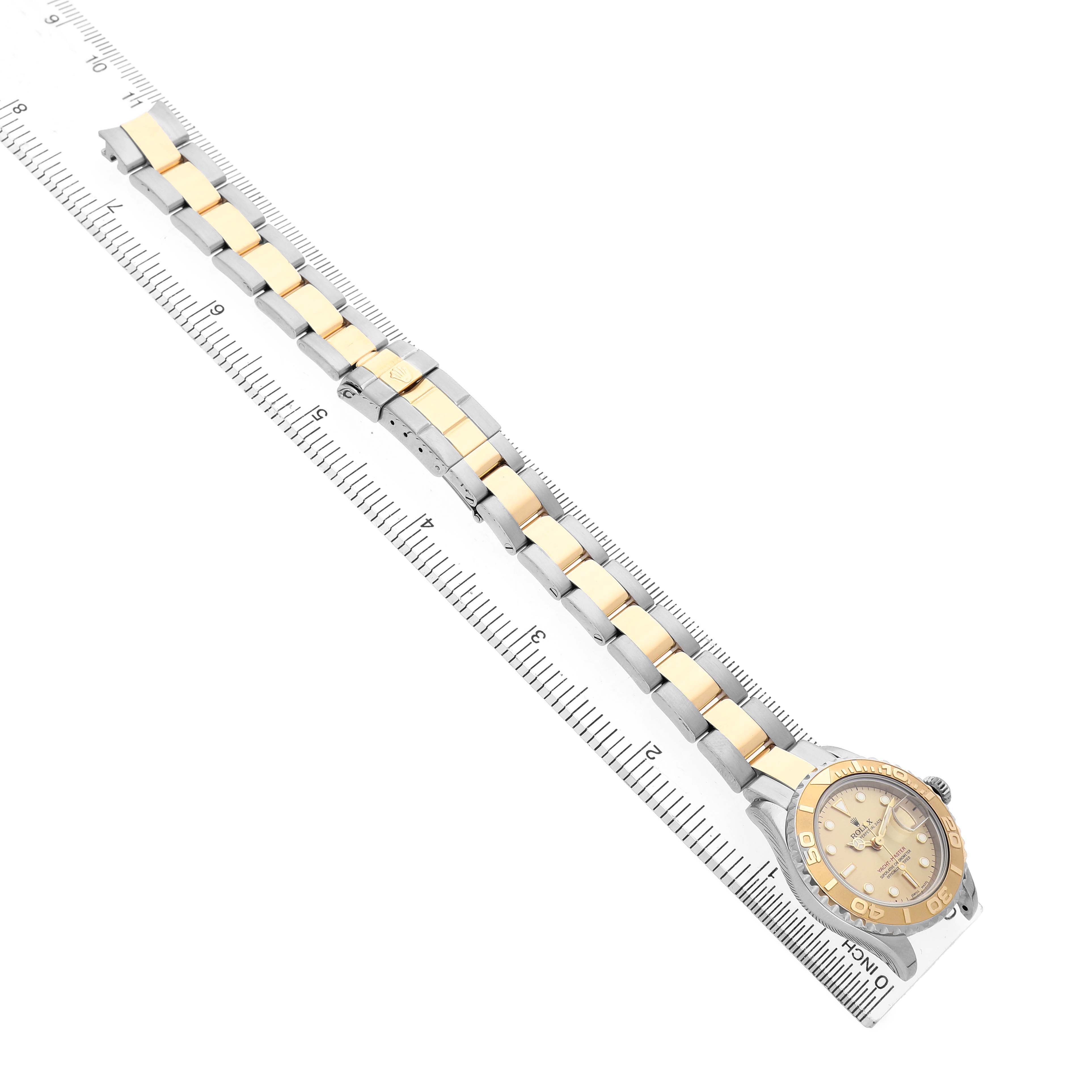 The Rolex Yacht-Master 169623 Women's Steel and Gold (two tone) Champagne Dial watch is shown at an angled top-down view, highlighting the bracelet, bezel, and dial.