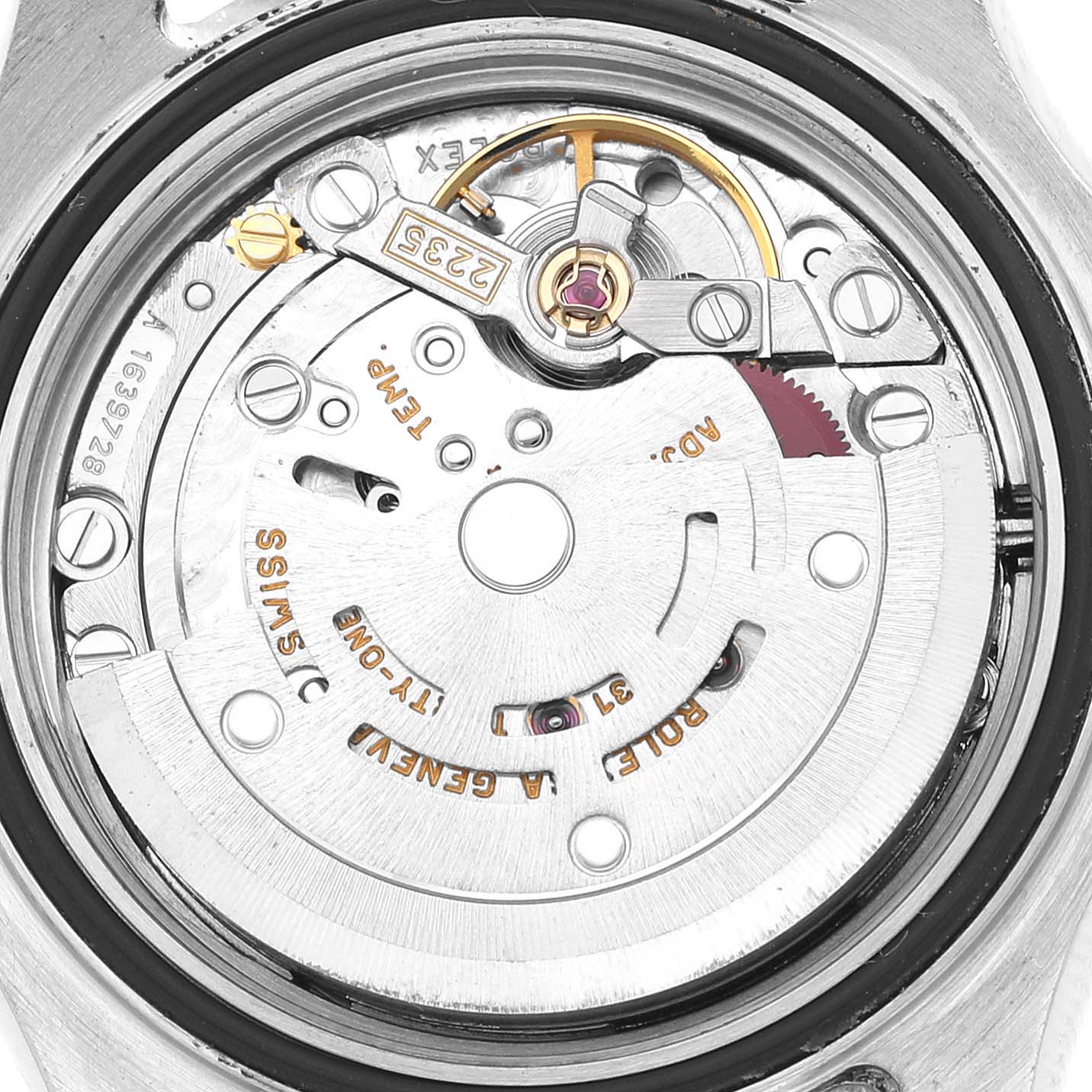 The image shows a close-up view of the Rolex Yacht-Master 169623 Women's Steel and Gold (two tone) Champagne Dial's movement, featuring gears and balance wheel components.