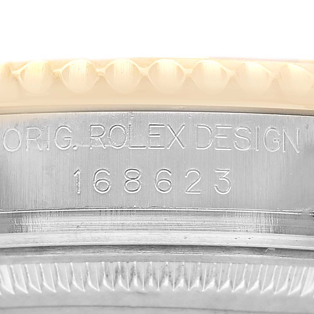 The image shows a close-up of the side of a Rolex Yacht-Master 168623 Men's Steel and Gold (two tone) Champagne Dial watch, highlighting the engraved design and model number 168623.