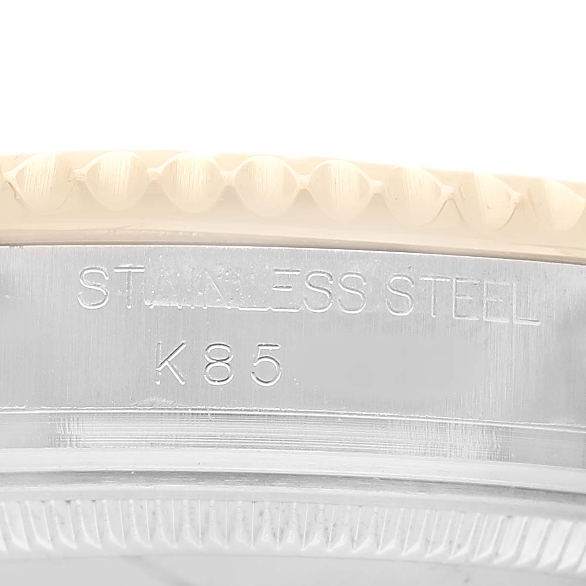The image shows a close-up of the side of the Rolex Yacht-Master 168623 Men's Steel and Gold (two tone) Champagne Dial watch, highlighting the edge with "STAINLESS STEEL" engraved.