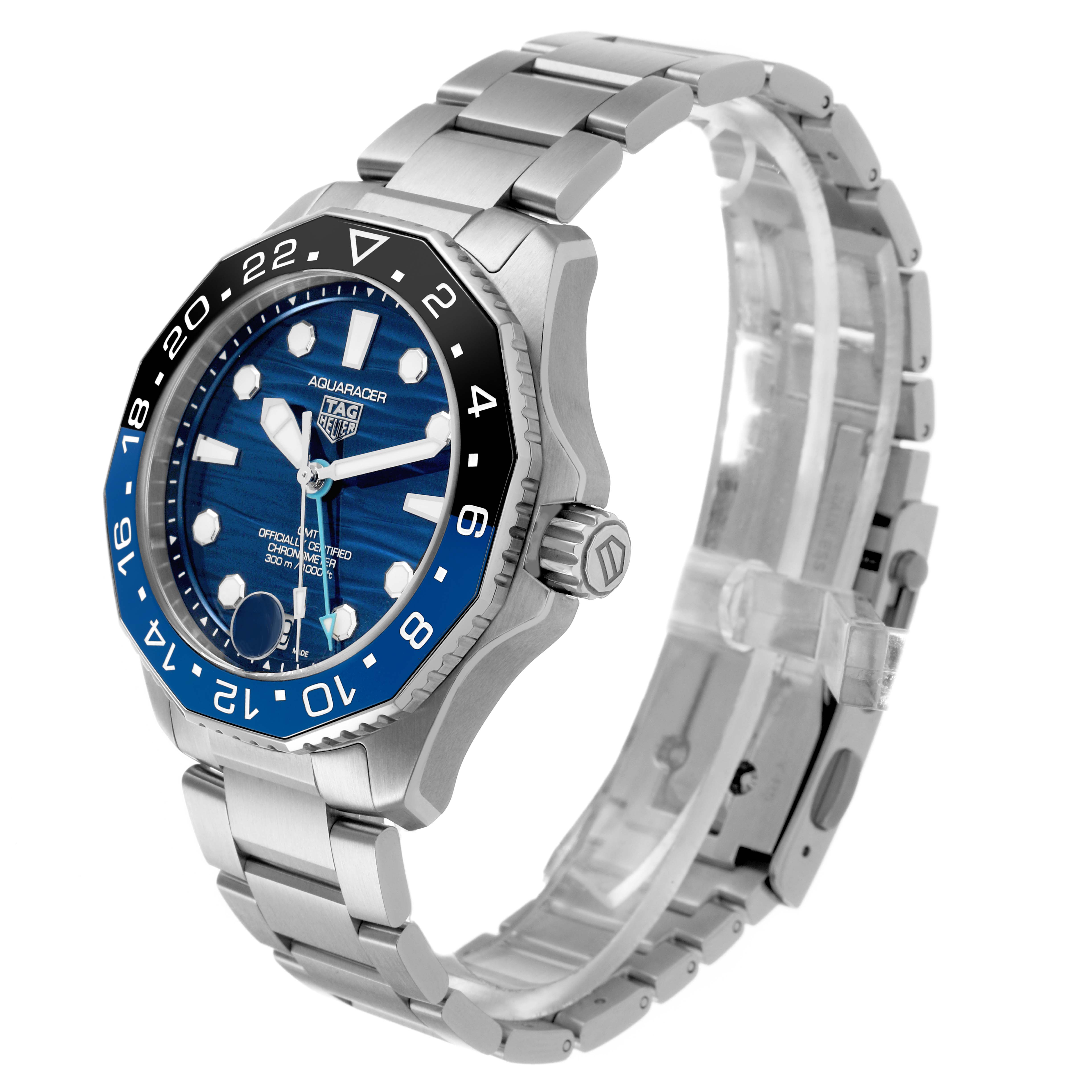 The TAG Heuer Aquaracer watch is shown at a three-quarter angle, displaying its blue dial, bezel, and metal bracelet.