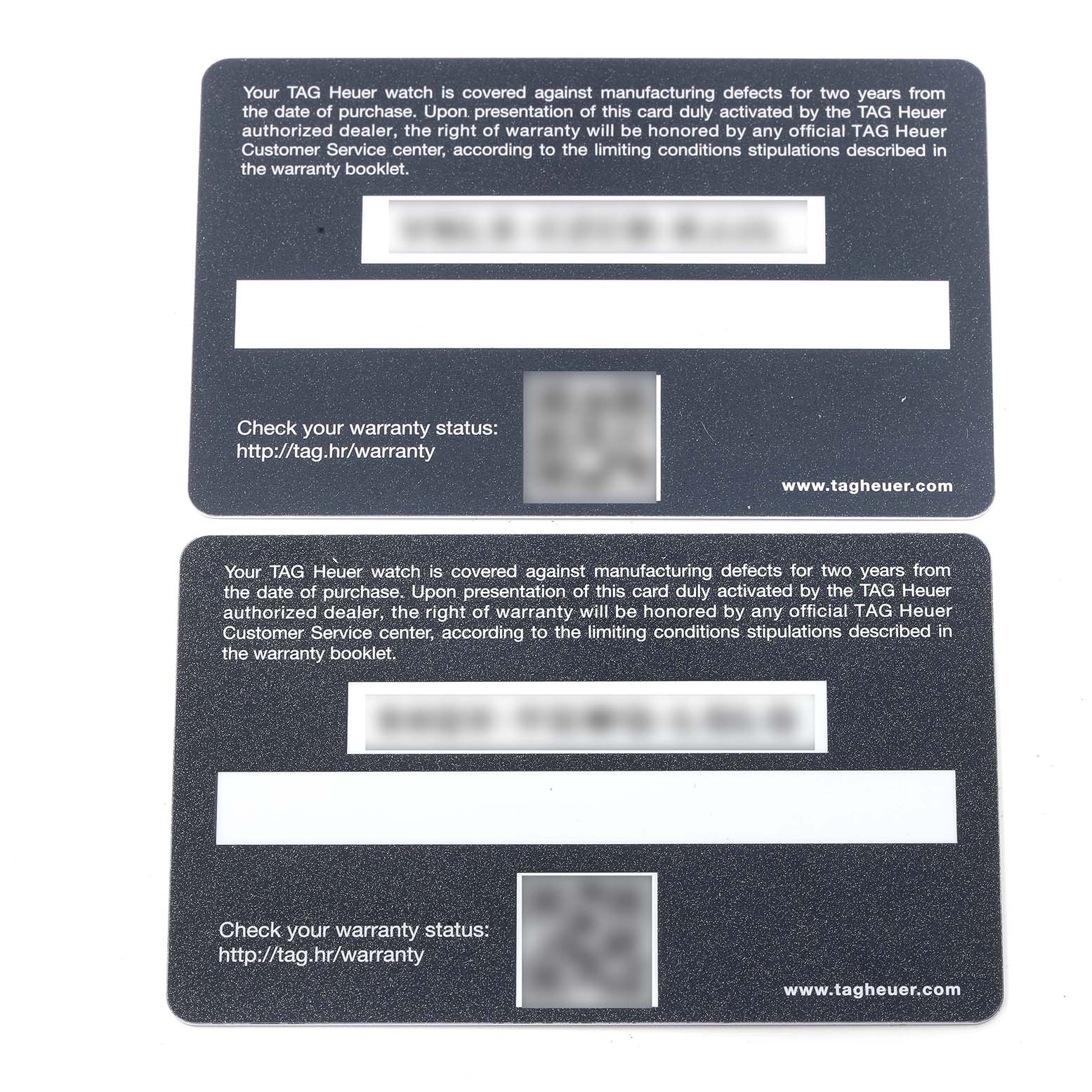 The image shows two TAG Heuer warranty cards for the Monaco model watch, viewed from a top-down angle.