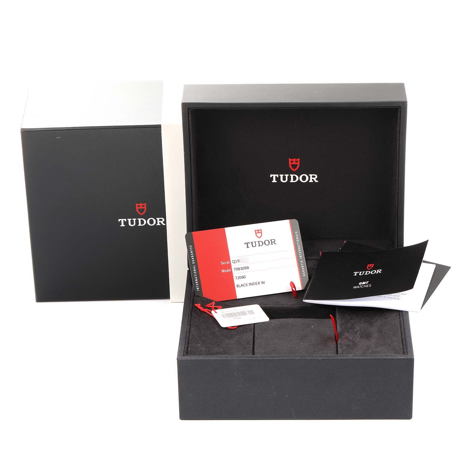 The image shows the packaging, warranty card, and booklets for the Tudor Heritage Black Bay 79830RB Men
s Stainless Steel Black Dial 79830RB Men
s Stainless Steel Black Dial watch.