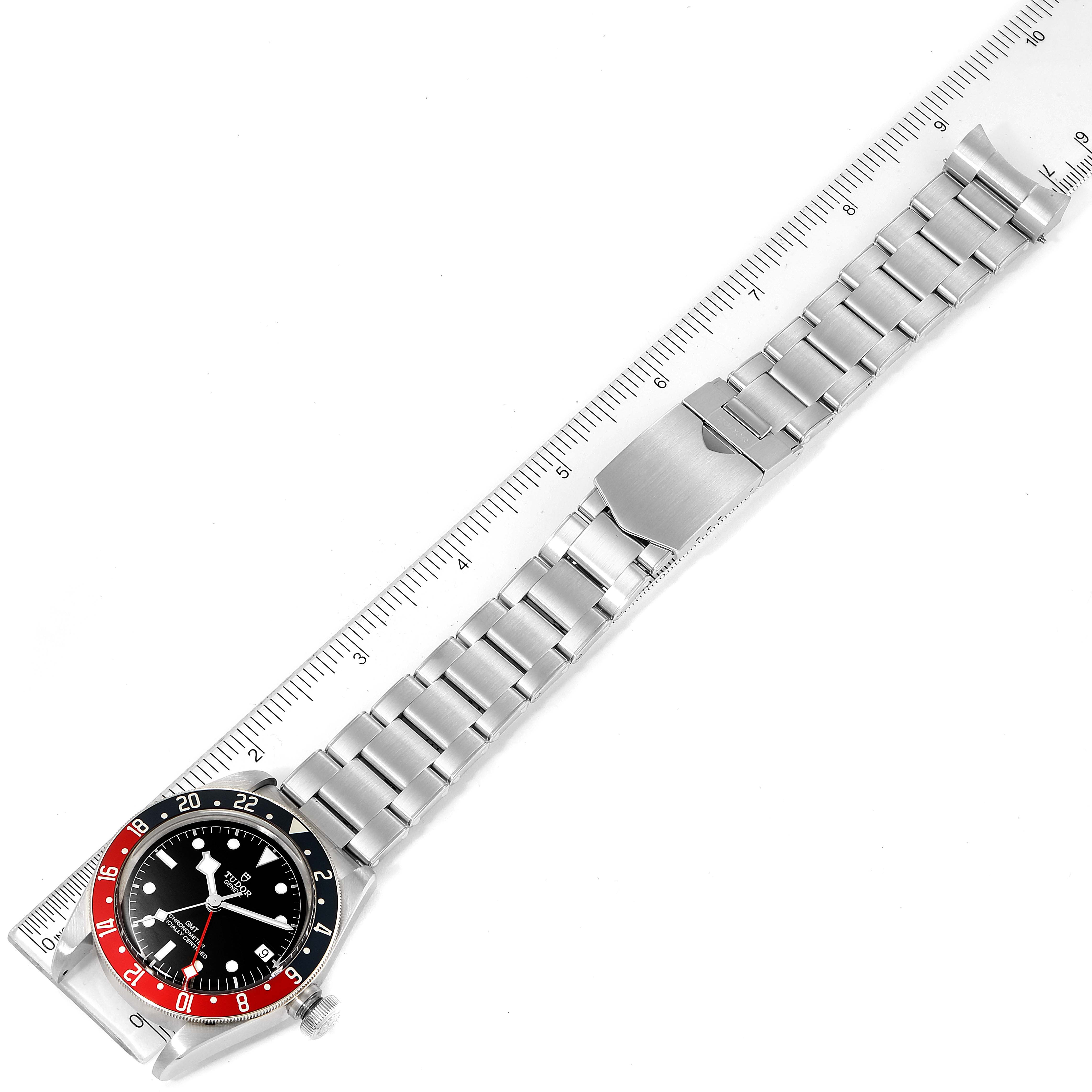 The image shows a top-down view of the Tudor Heritage Black Bay 79830RB Men
s Stainless Steel Black Dial 79830RB Men
s Stainless Steel Black Dial watch, highlighting the face, bezel, and metal bracelet with a clasp.