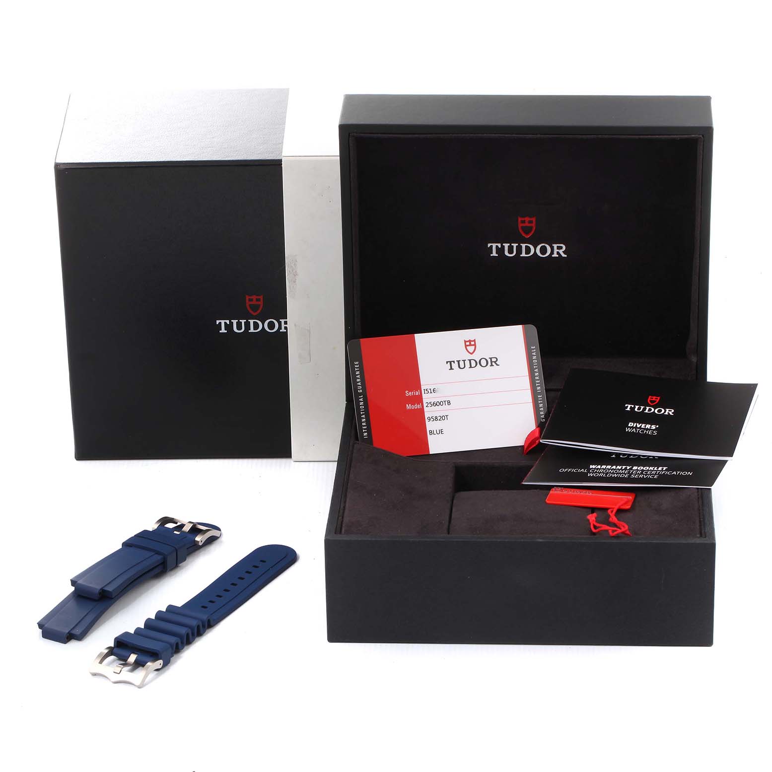 The image shows the packaging, warranty card, and additional straps of a Tudor Pelagos 25600TV Men
s Titanium Blue Dial 25600TV Men
s Titanium Blue Dial watch.