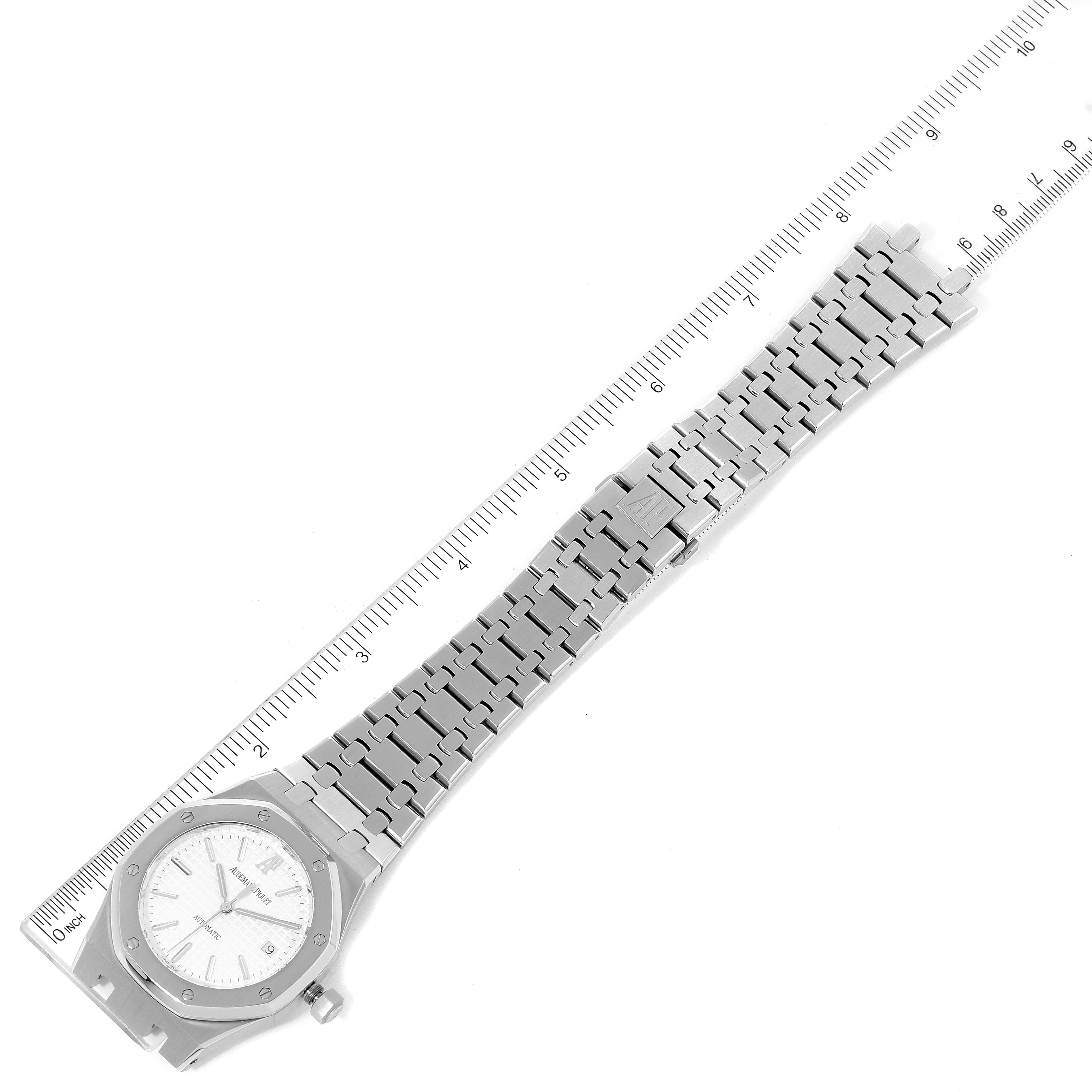 The image shows an Audemars Piguet Royal Oak 15300ST Men
s Stainless Steel White Dial 15300ST Men
s Stainless Steel White Dial watch laid flat, showcasing the face, bracelet, and clasp, measured against a ruler.
