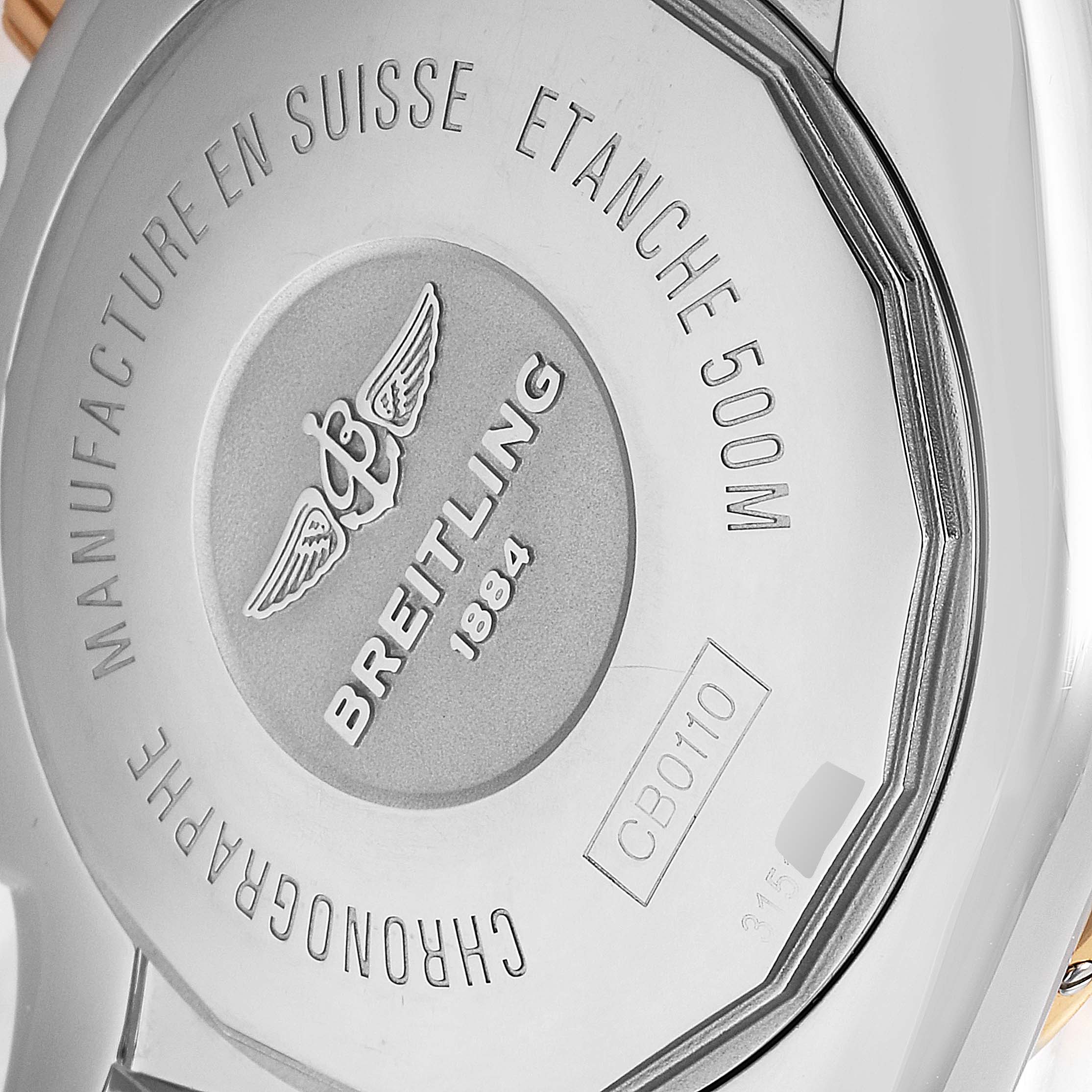 The image shows the back case of a Breitling Chronomat CB011012 Men's Steel and Gold (two tone) Black Dial CB011012 Men's Steel and Gold (two tone) Black Dial watch with engravings.