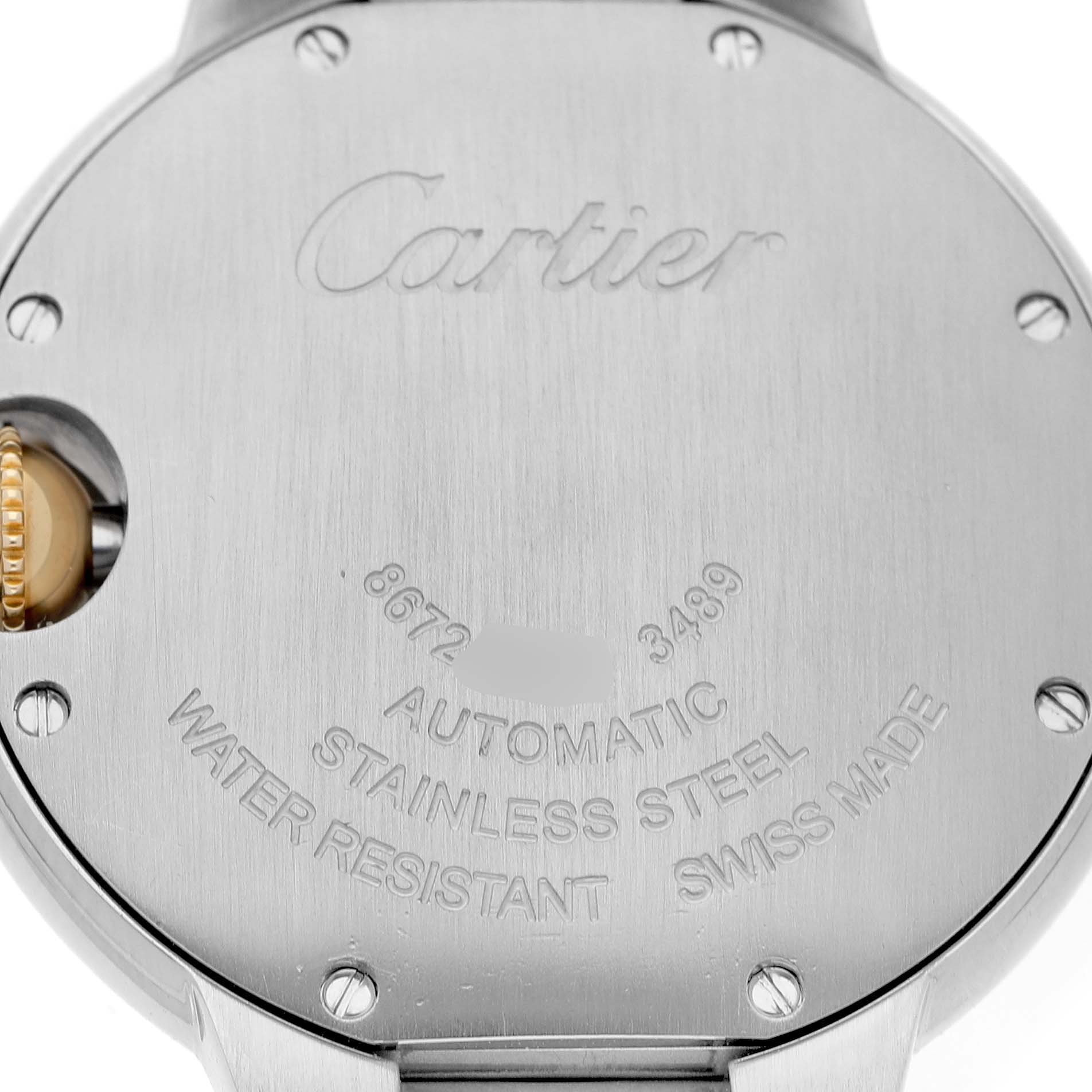 The image shows the back casing of a Cartier Ballon Bleu W2BB0002 Women's Stainless Steel Silver Dial watch, highlighting its engraved details and crown.