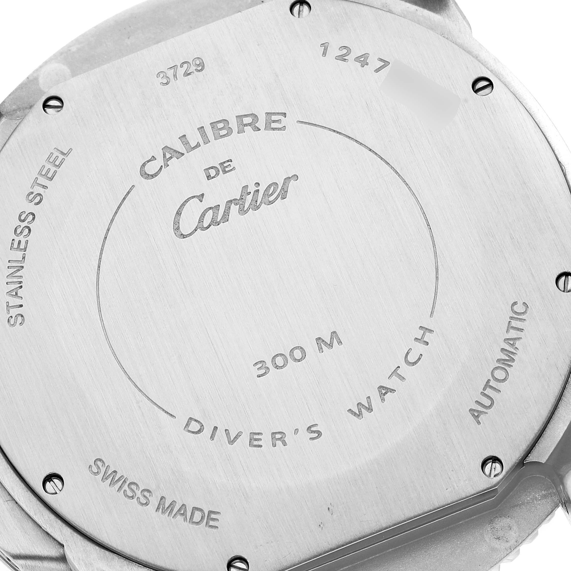 The image shows the back case of a Calibre de Cartier watch by Cartier, featuring engraved details about the model and specifications.