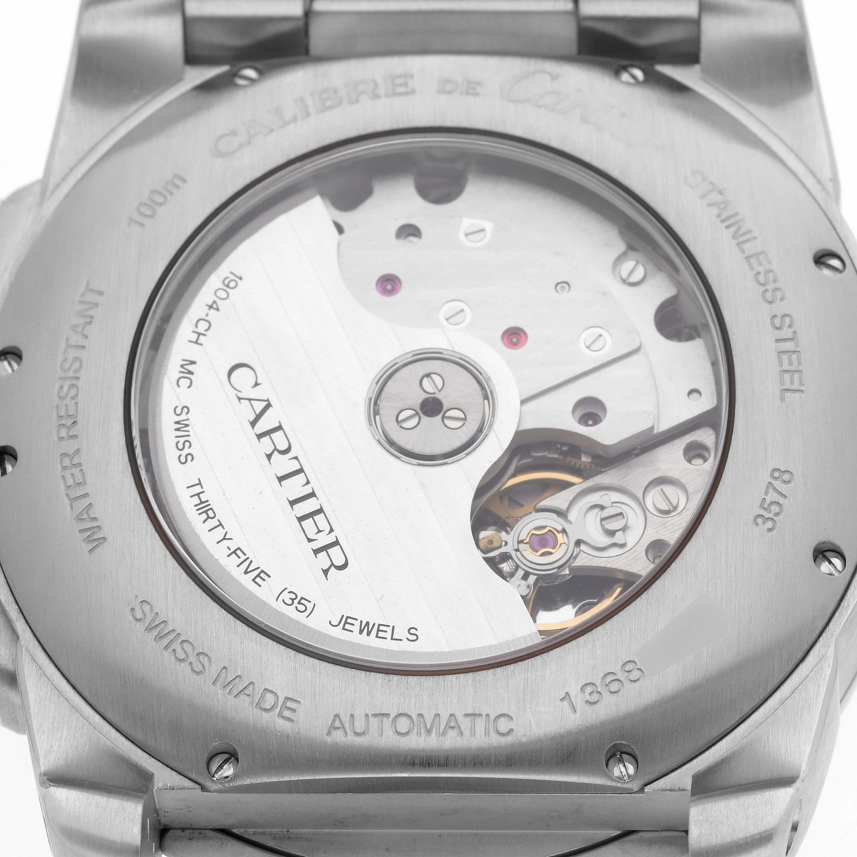 The image shows the case back of the Calibre de Cartier watch, featuring its movement and engraving details.