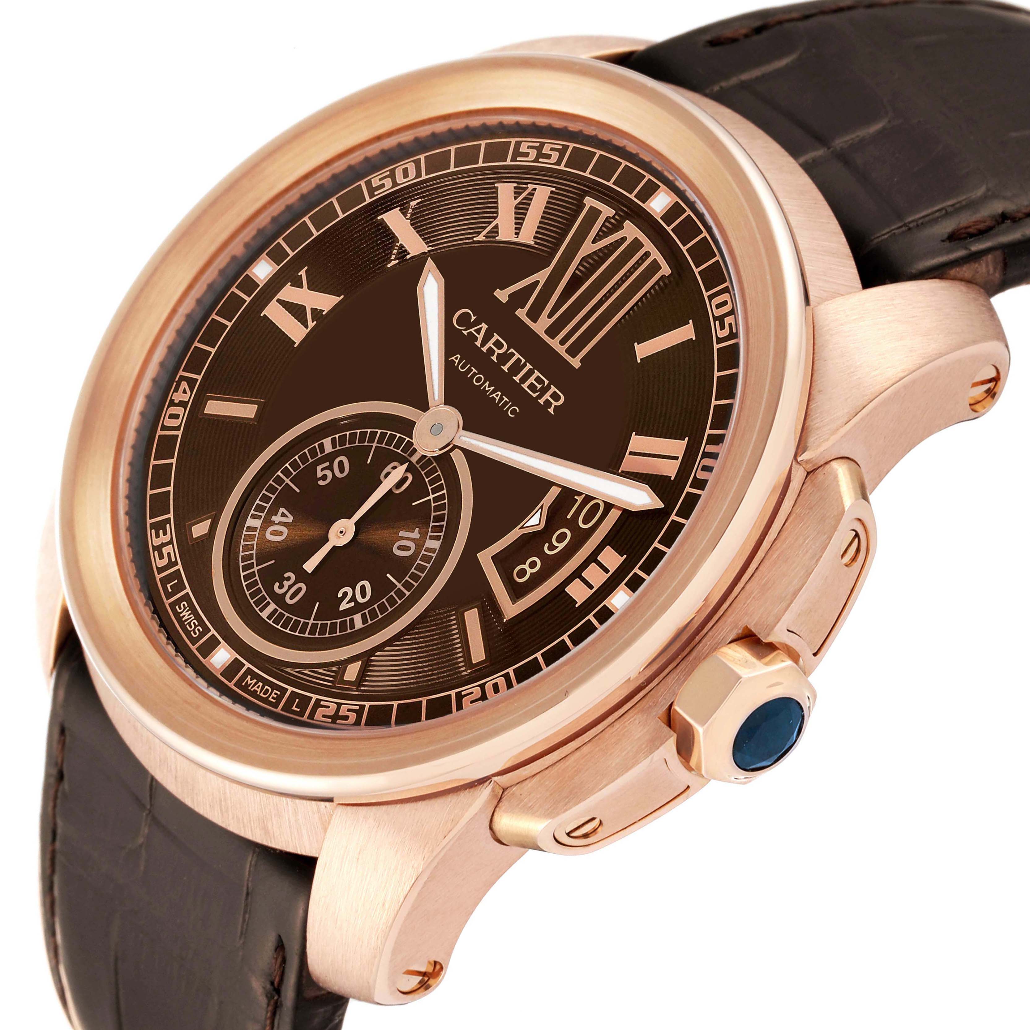 The image shows a close-up, angled view of the Calibre de Cartier watch, highlighting the rose gold case, black dial, and leather strap.