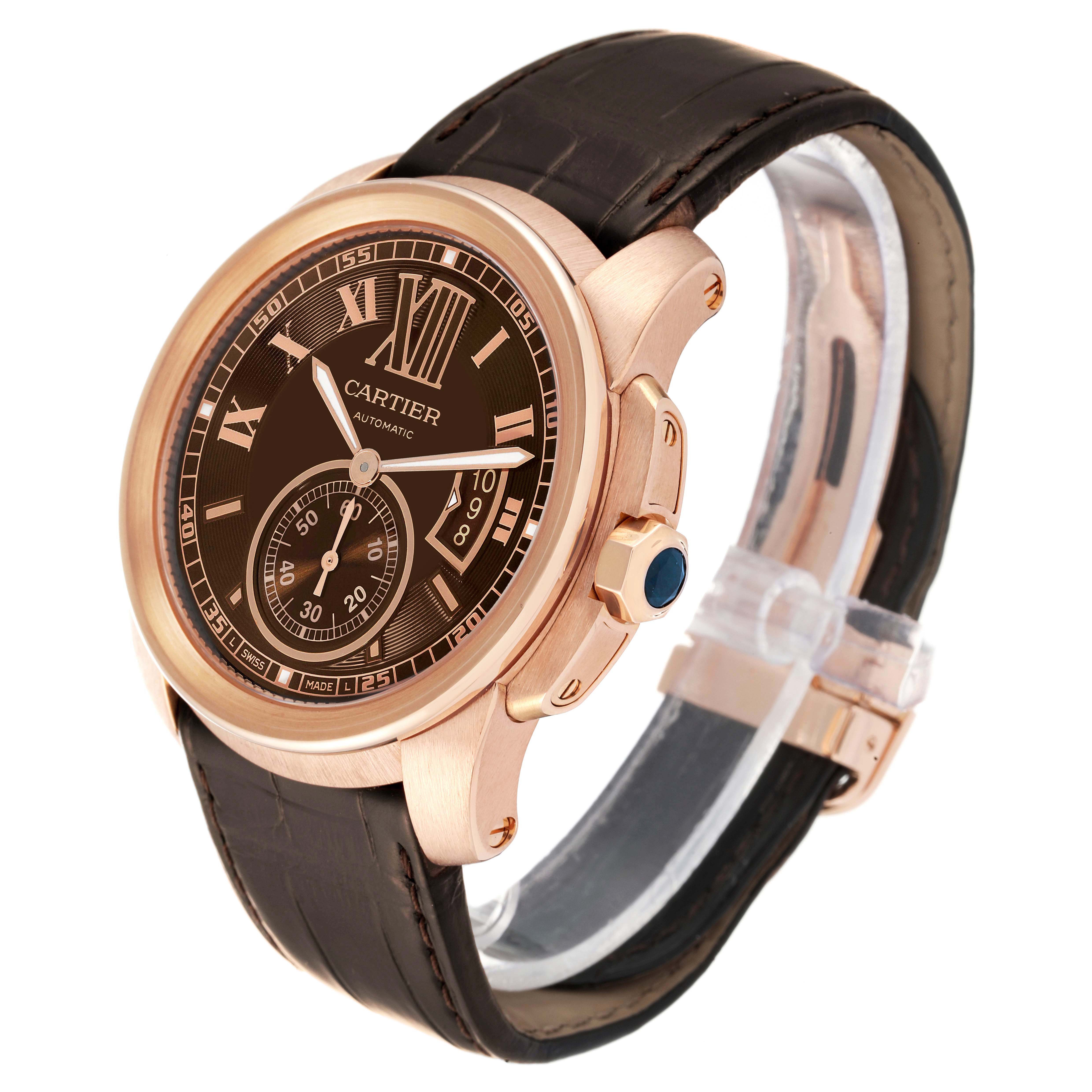 This image displays a Calibre de Cartier watch by Cartier at a three-quarter angle, showcasing its dial, case, and leather strap.