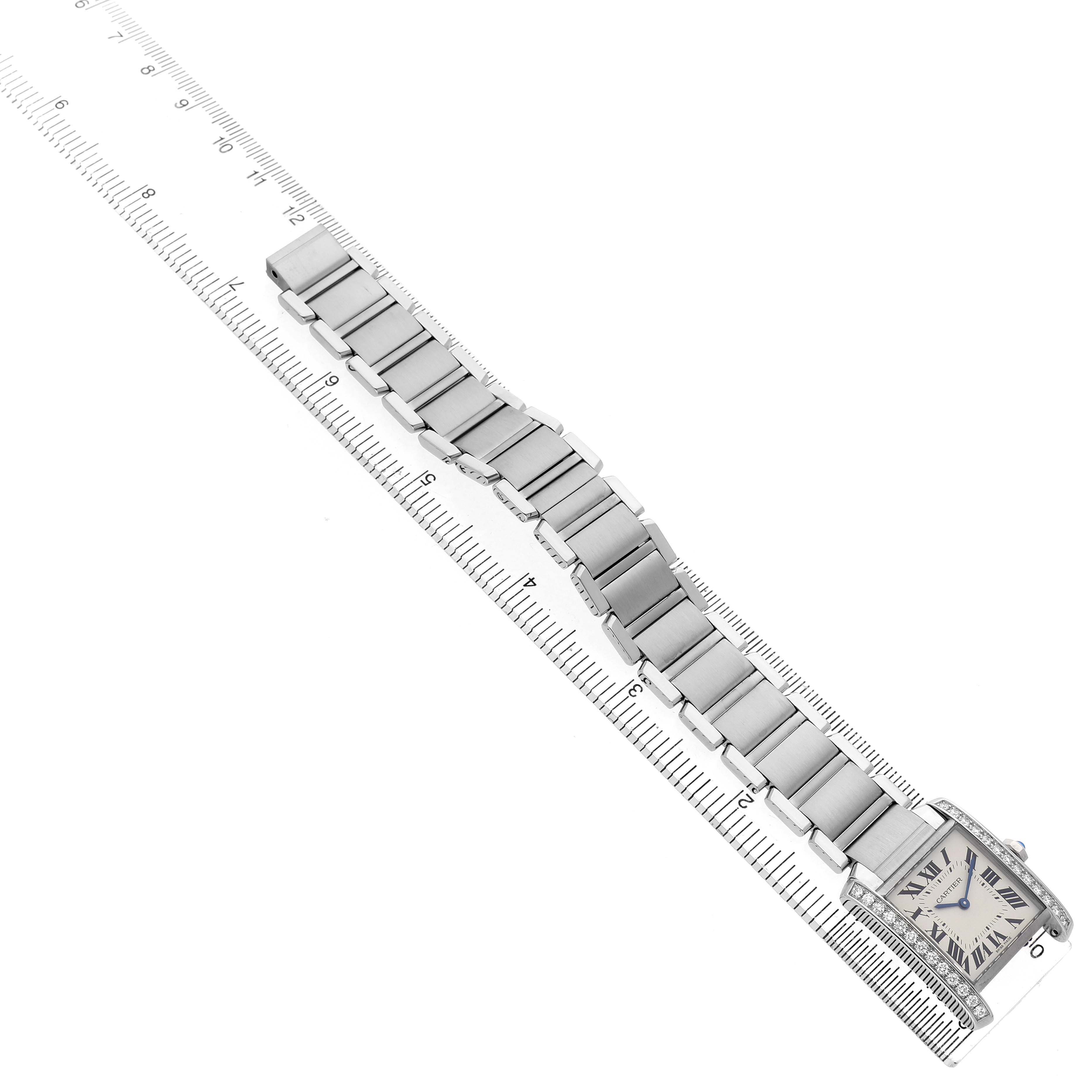 The Cartier Tank Francaise W4TA0009 Women's Stainless Steel Silver Dial watch is shown from a top angle, with emphasis on the bracelet and a ruler for scale.