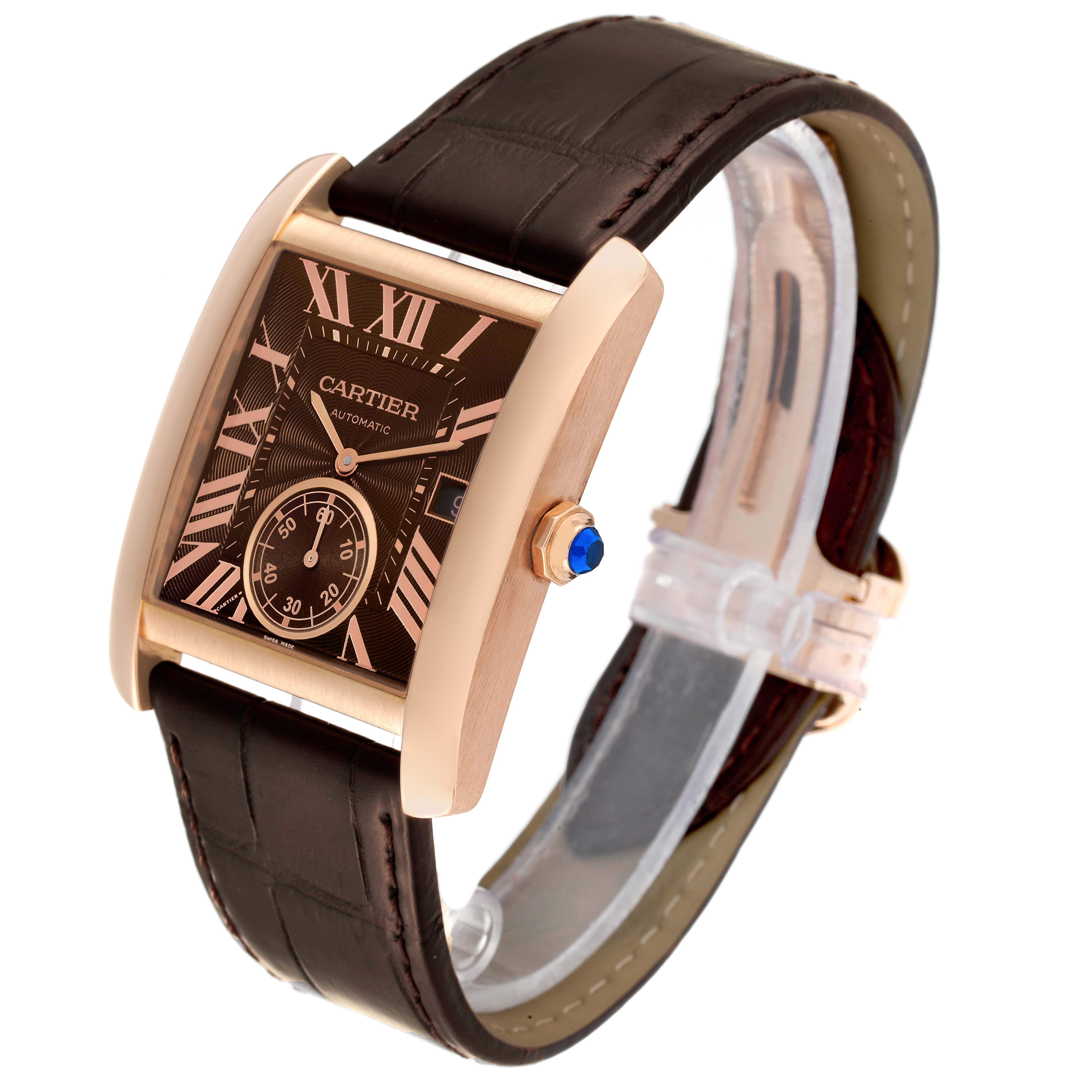 This Cartier Tank MC W5330002 Men
s Rose Gold Brown Dial W5330002 Men
s Rose Gold Brown Dial watch is shown at a tilted angle, highlighting its rectangular dial, brown leather strap, rose gold casing, and blue crown.