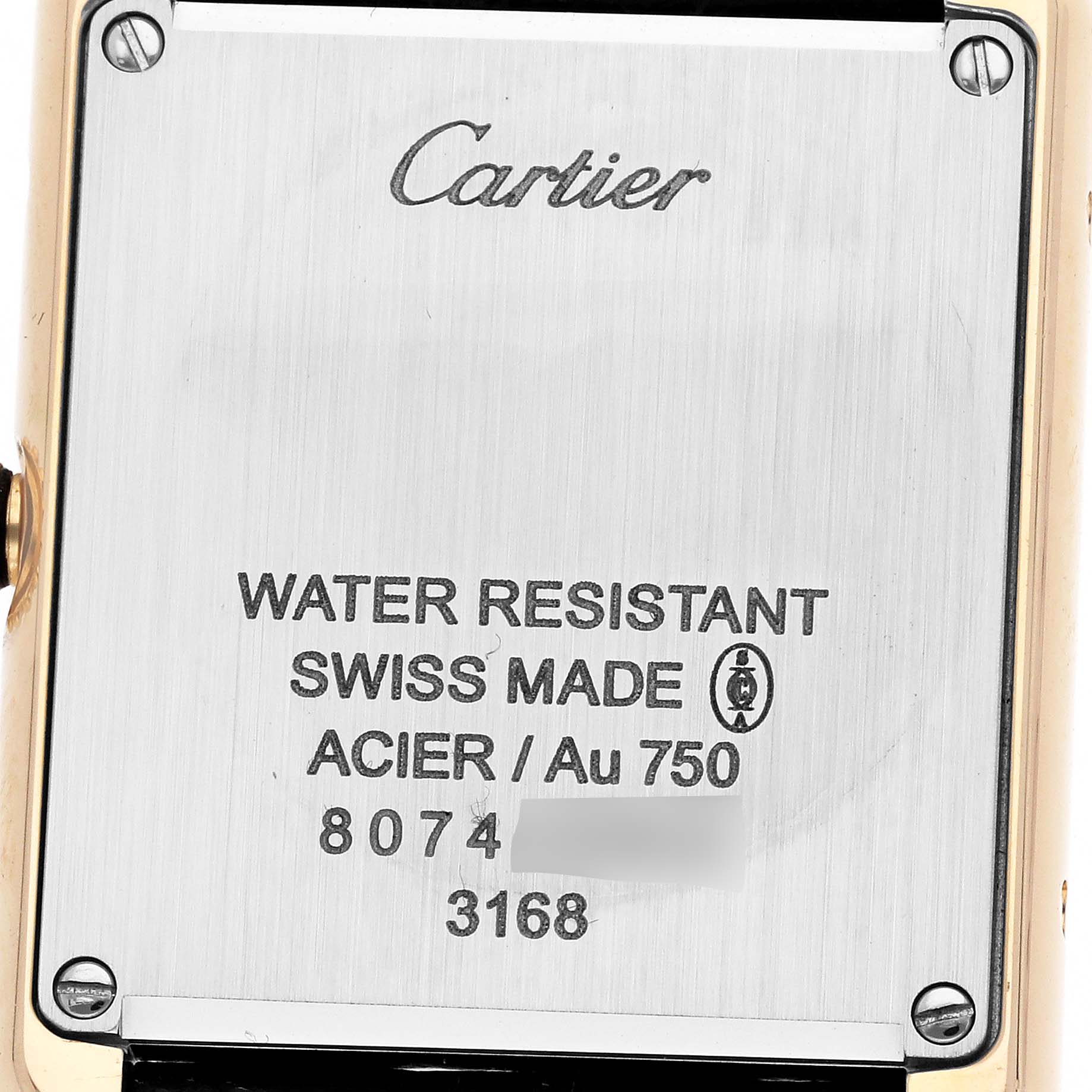 The image shows the case back of a Cartier Tank Solo W5200002 Women's Yellow Gold White Dial watch, highlighting the brand engraving and specifications.