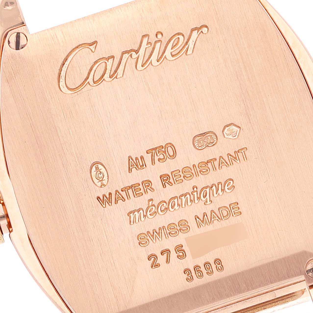 This is a close-up of the back case of the Cartier Tortue WA501010 Women
s Rose Gold Silver Dial WA501010 Women
s Rose Gold Silver Dial watch, detailing the inscriptions and materials.