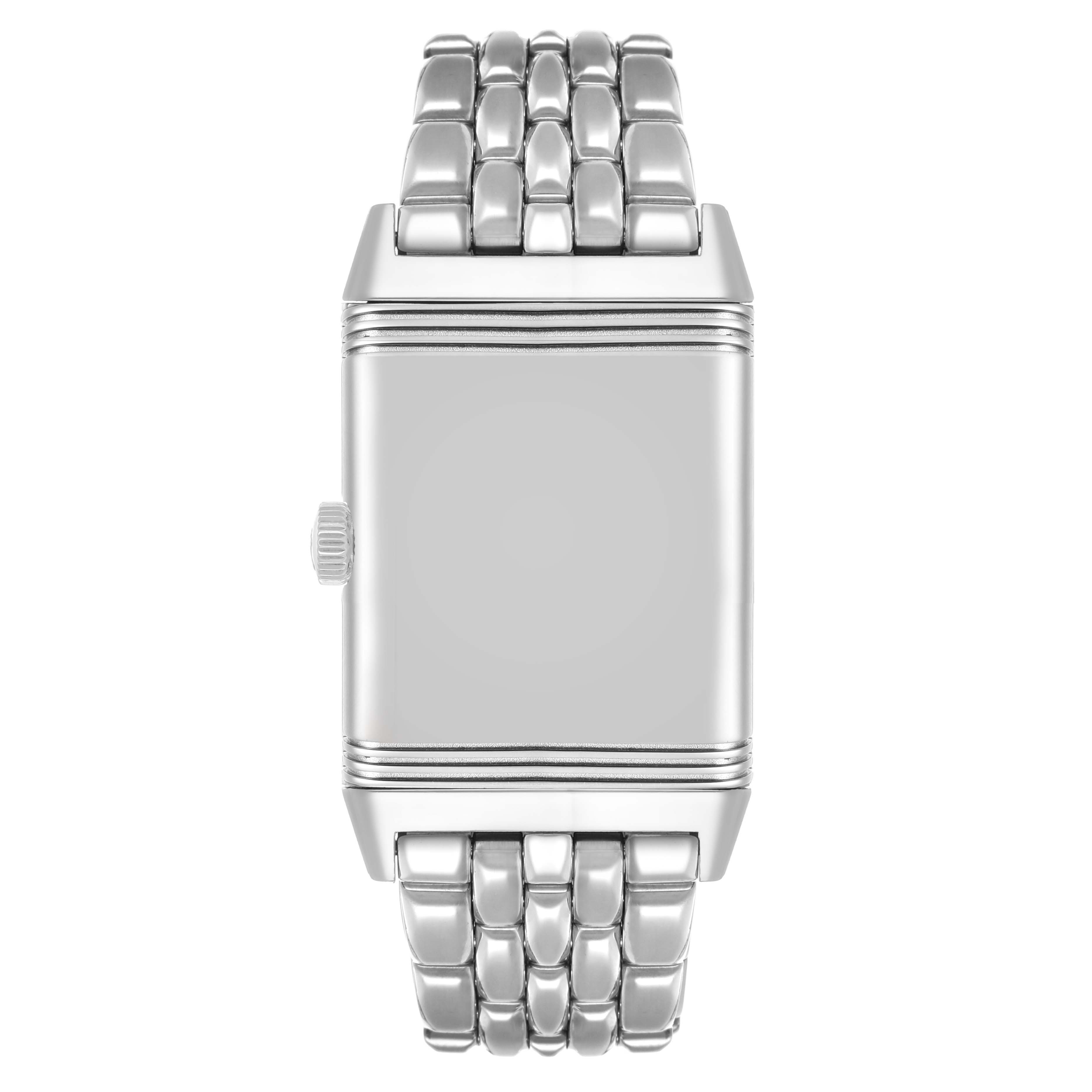 The Jaeger-LeCoultre Reverso watch is shown from the front, highlighting its rectangular case and metal bracelet.