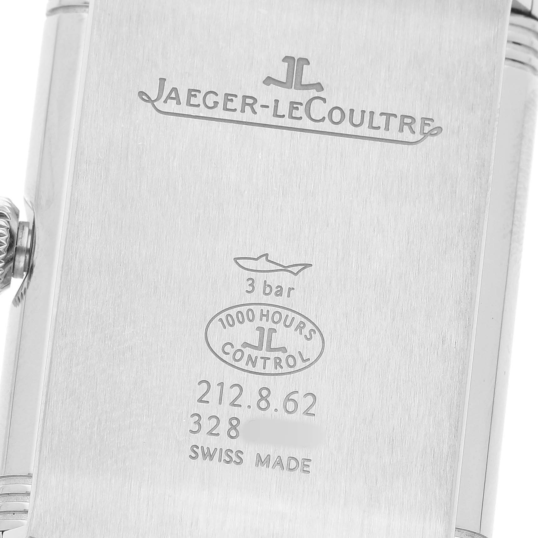 The image shows the case back of a Jaeger-LeCoultre Reverso watch, highlighting the engravings and crown.