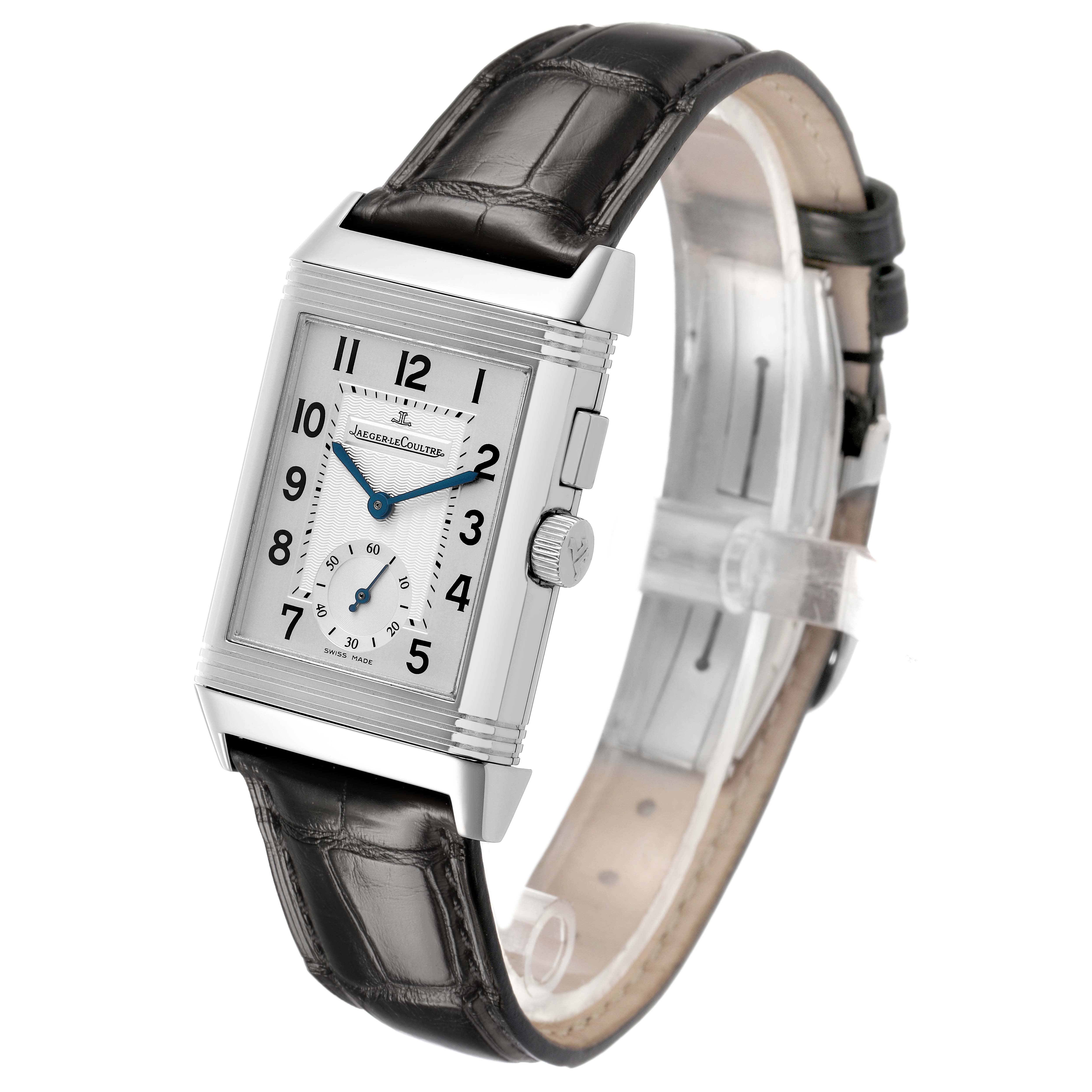 The Jaeger-LeCoultre Reverso watch is shown at a slight angle, displaying its rectangular face, side crown, and leather strap.