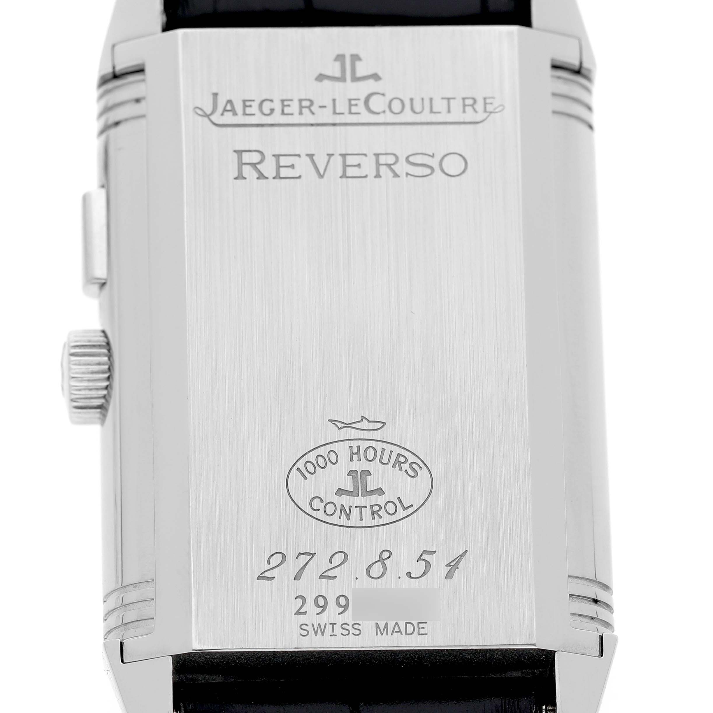 The image shows the back case of a Jaeger-LeCoultre Reverso watch, featuring engraved branding and details.