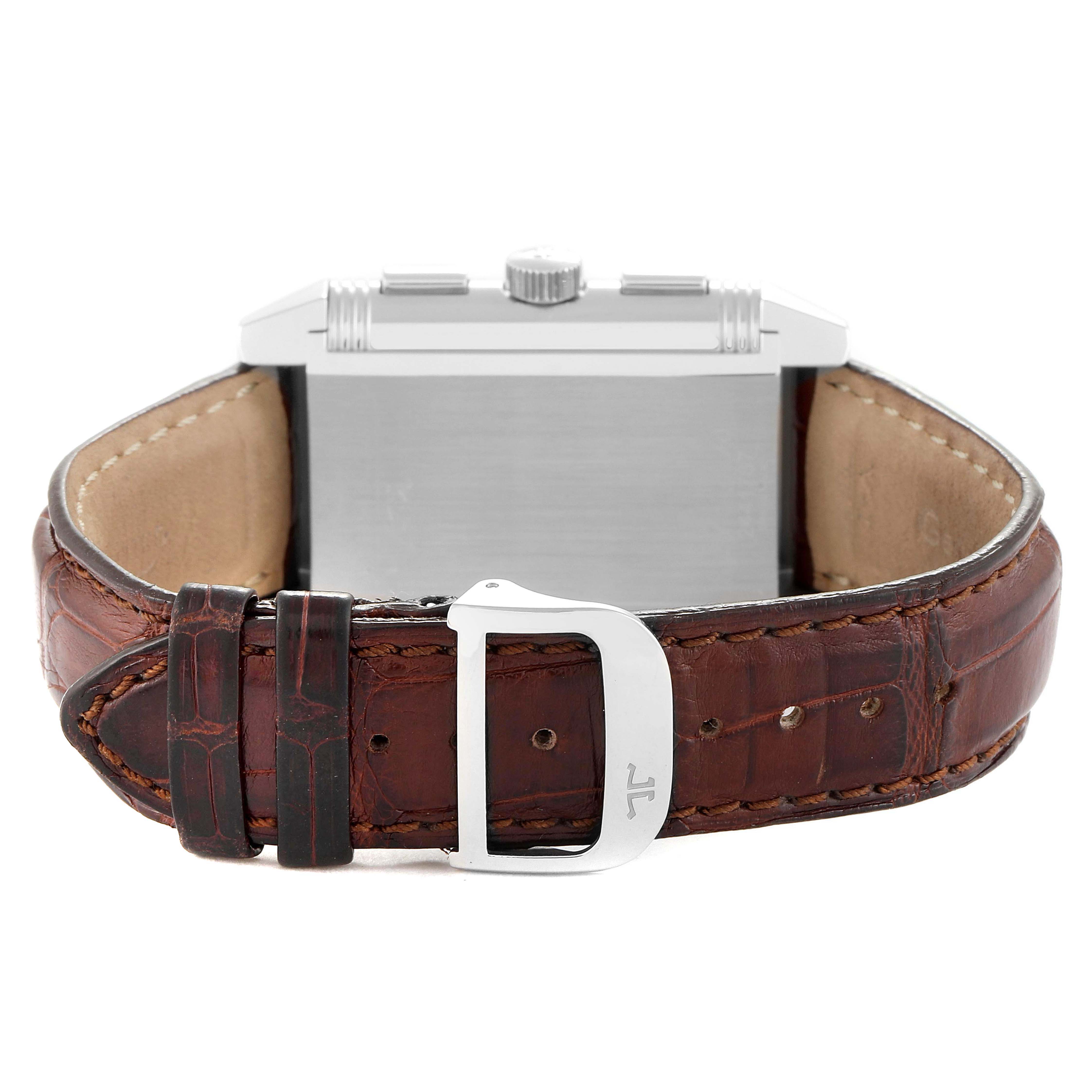 The Jaeger LeCoultre Reverso Q3028420 / 240.8.18 Men's Stainless Steel Silver Dial watch is shown from the side, highlighting the crown, case, and brown leather strap with buckle.