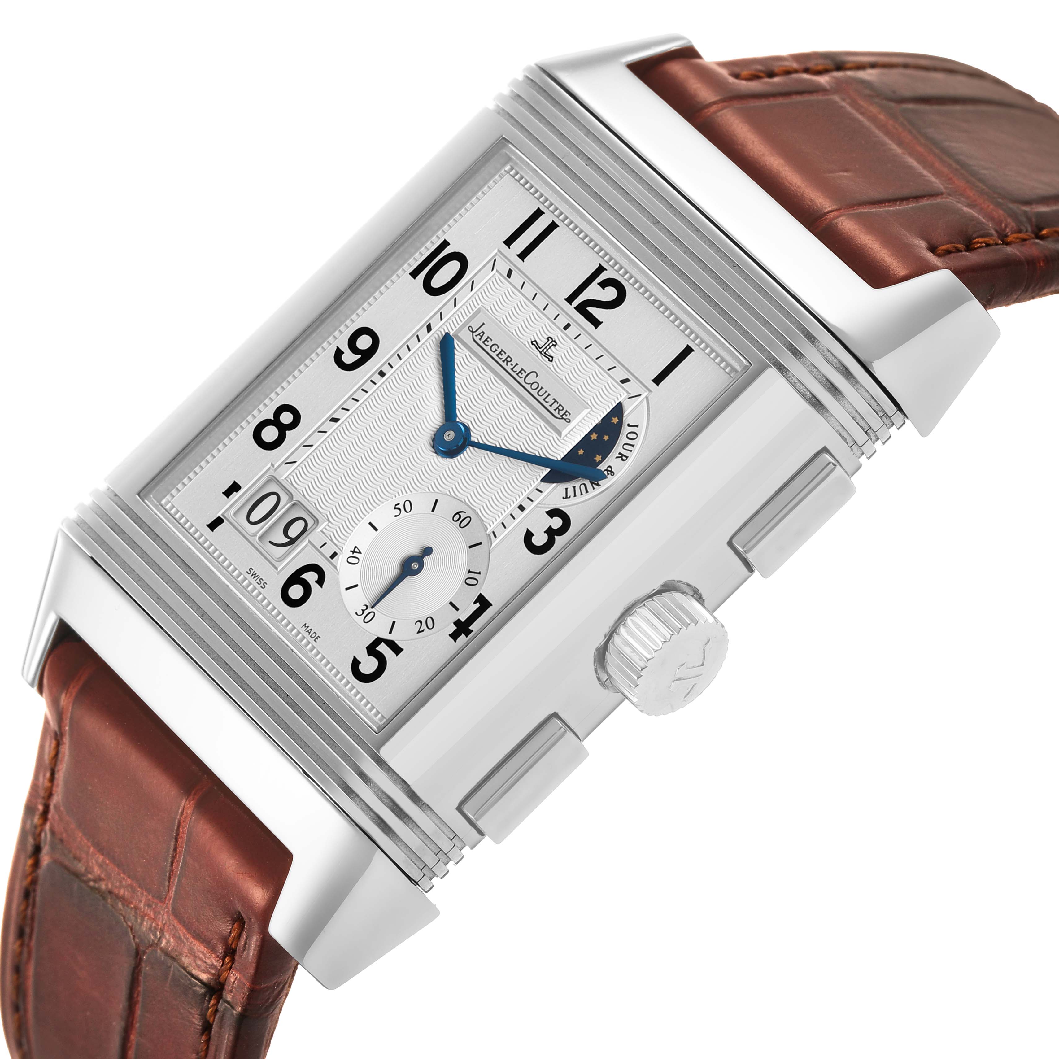 The Jaeger-LeCoultre Reverso watch is shown at an angle highlighting its dial, hands, crown, and leather strap.