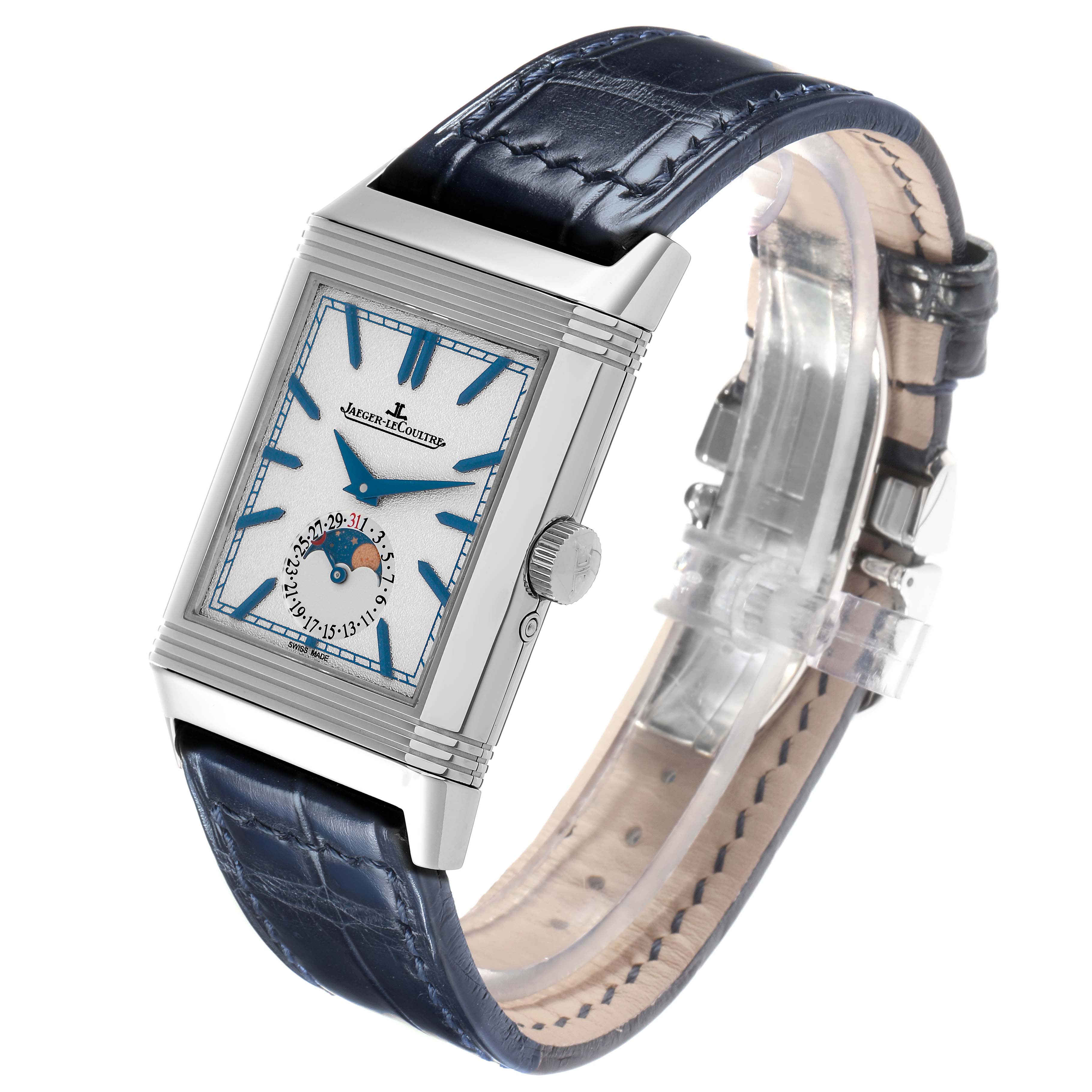 The Jaeger-LeCoultre Reverso watch is shown at a slight angle, displaying its rectangular face, blue leather strap, and visible crown.