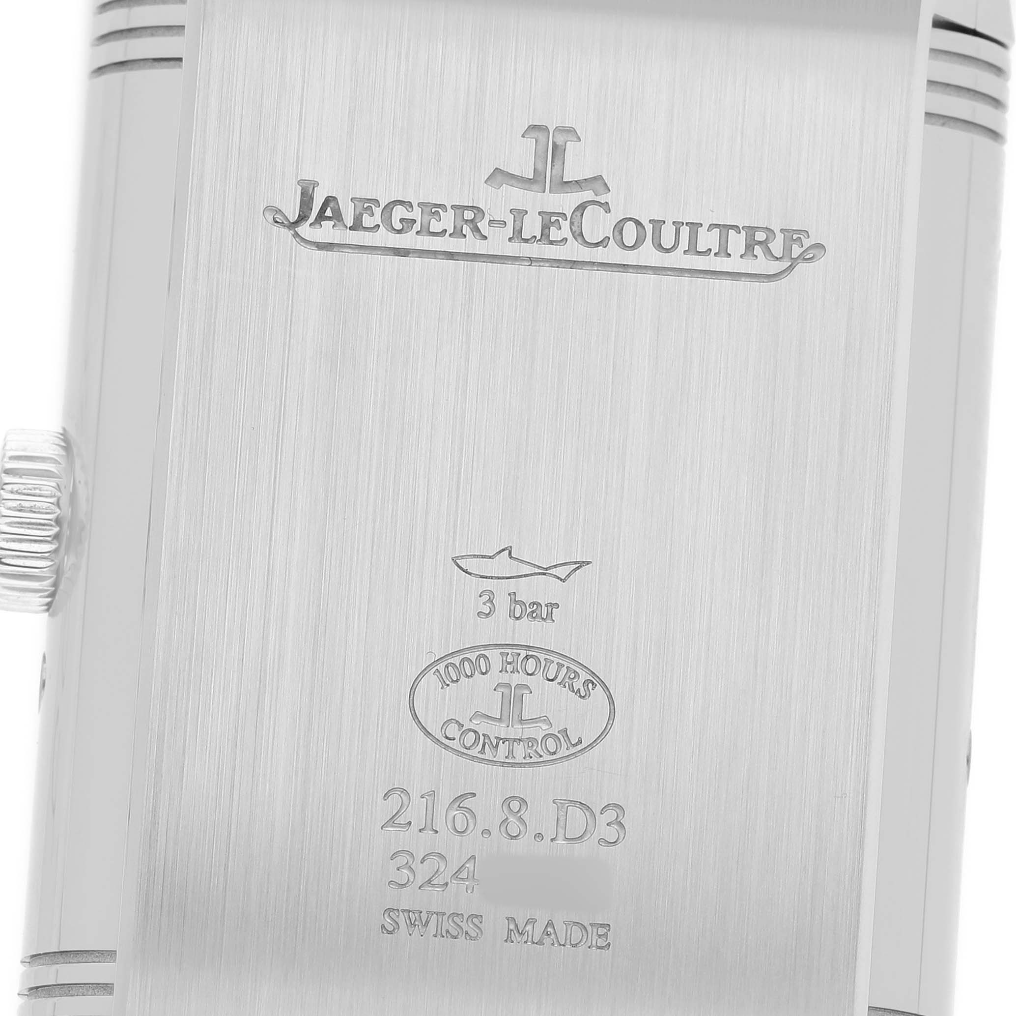 The image shows the back of the Jaeger-LeCoultre Reverso, featuring engraving details and the watch's crown.