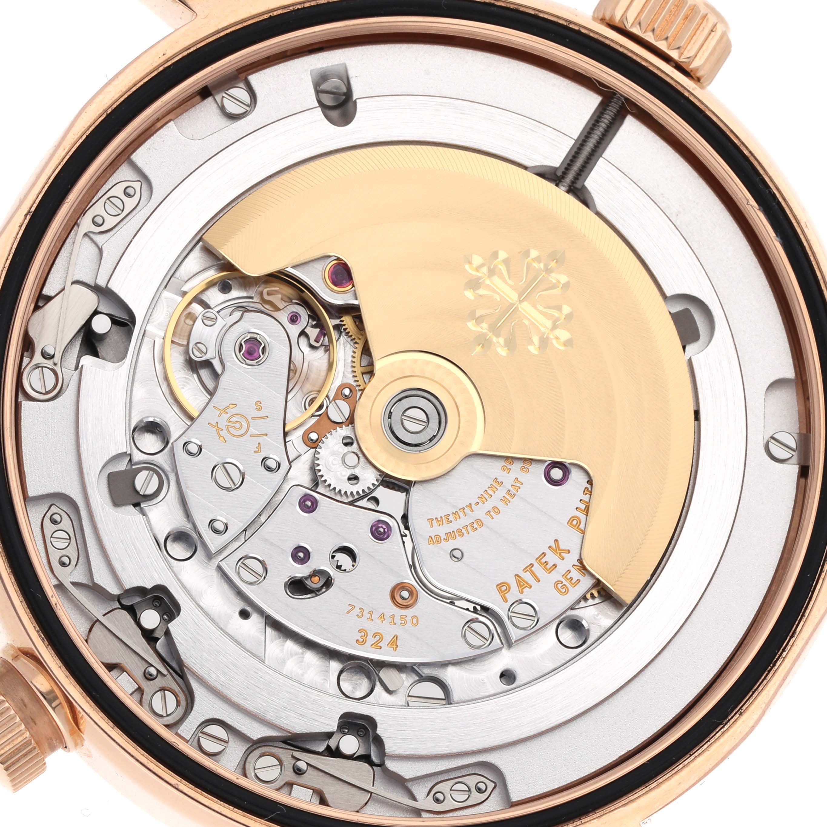 The image shows the movement of a Patek Philippe Calatrava 5524R-001 Men
s Rose Gold Brown Dial watch from the back, highlighting the rotor and intricate mechanics.