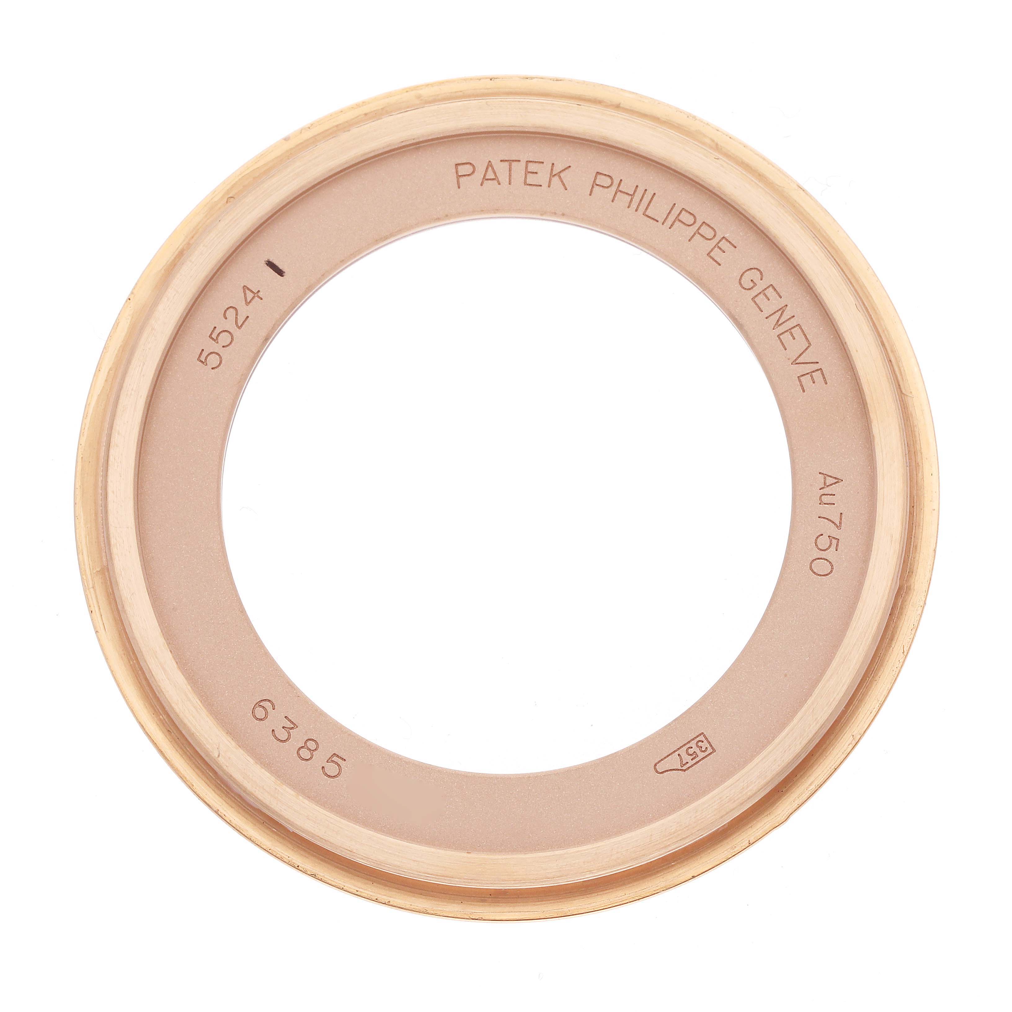 The image shows a top-down view of a Patek Philippe Calatrava 5524R-001 Men
s Rose Gold Brown Dial watch bezel, engraved with model and material details.