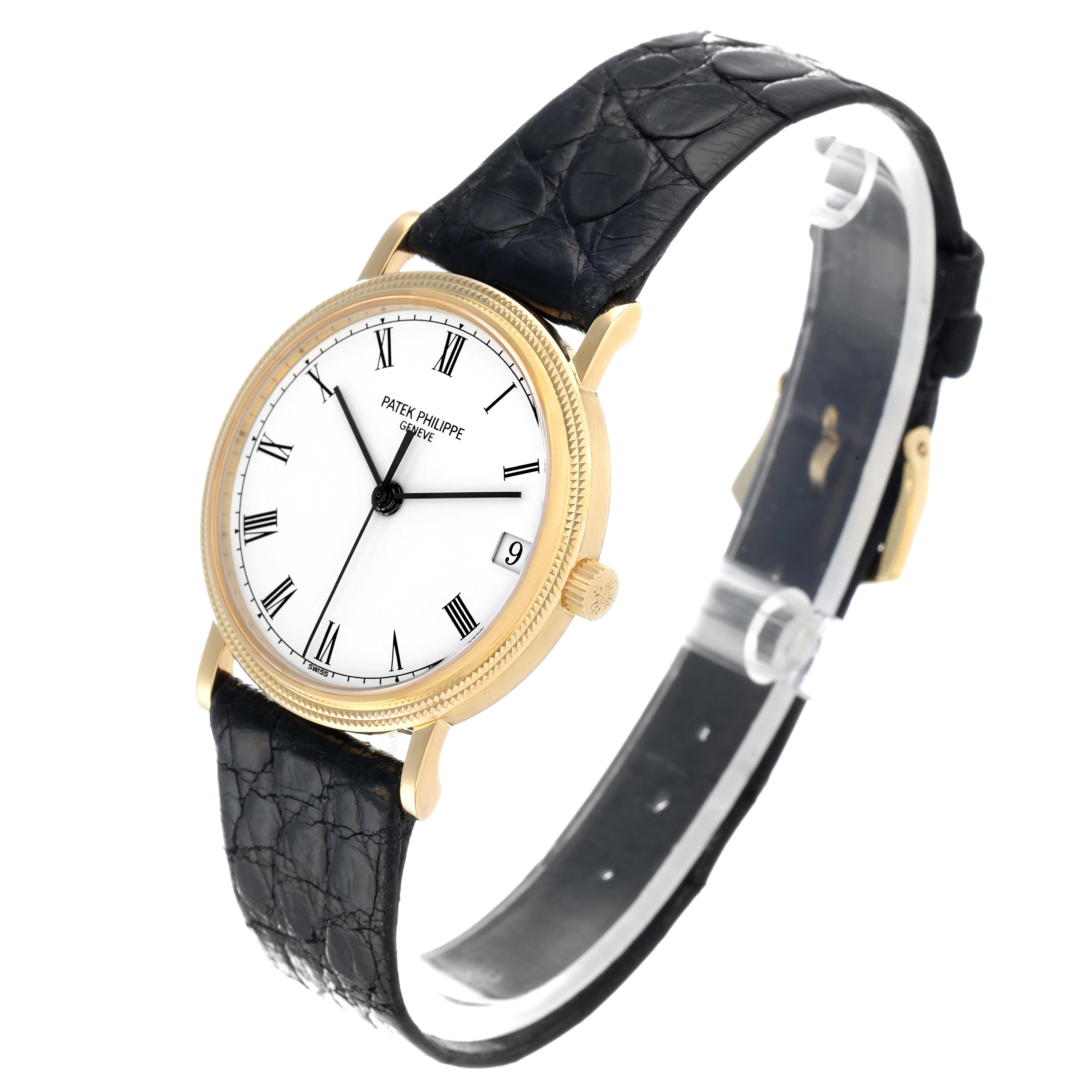 The Patek Philippe Calatrava 3802J Men
s Yellow Gold White Dial is shown at a slight side angle, displaying the face, case, and black strap.