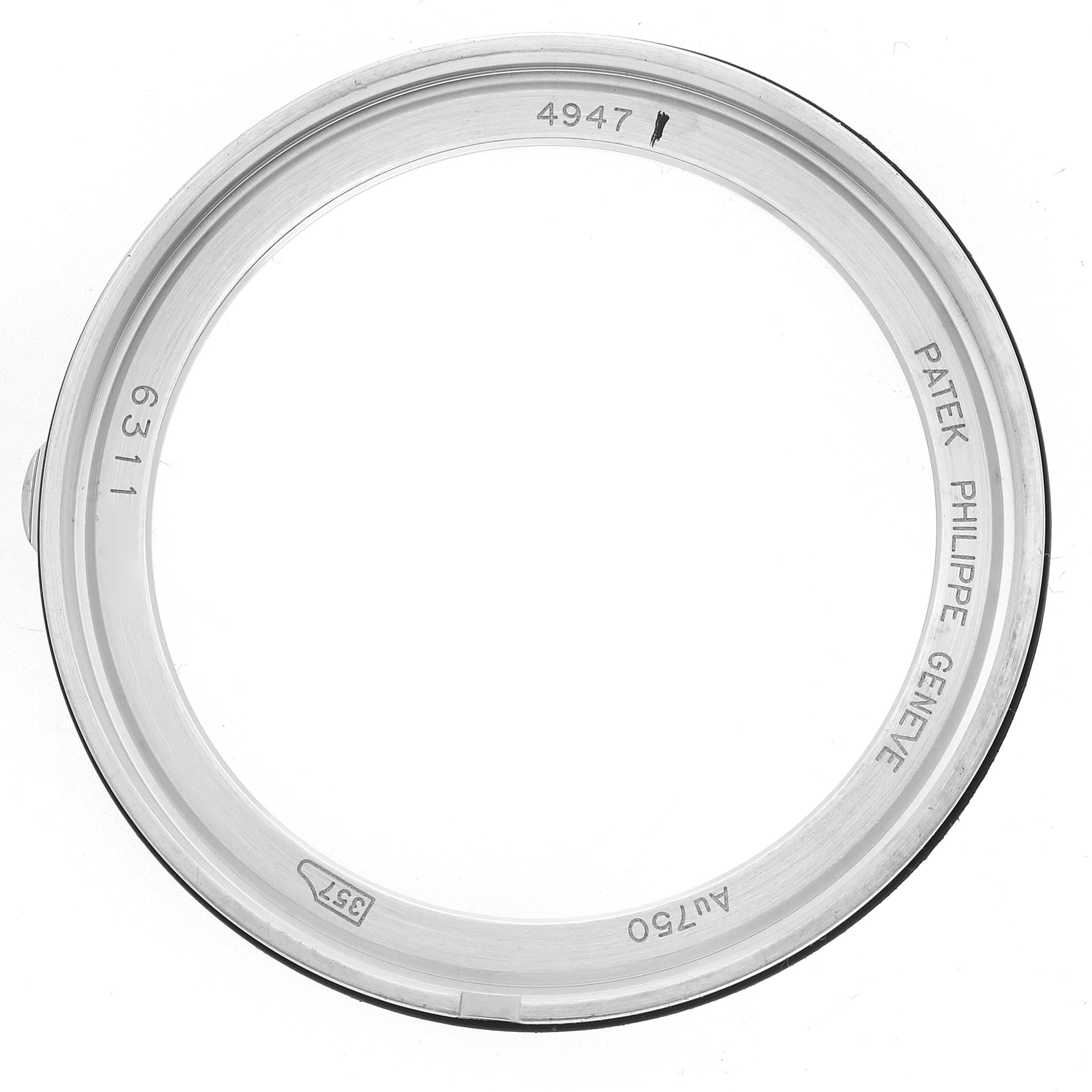 The image shows the bezel of a Patek Philippe Complications 4947G-001 Men
s White Gold Blue Dial watch, viewed from above with inscriptions visible on the inner surface.