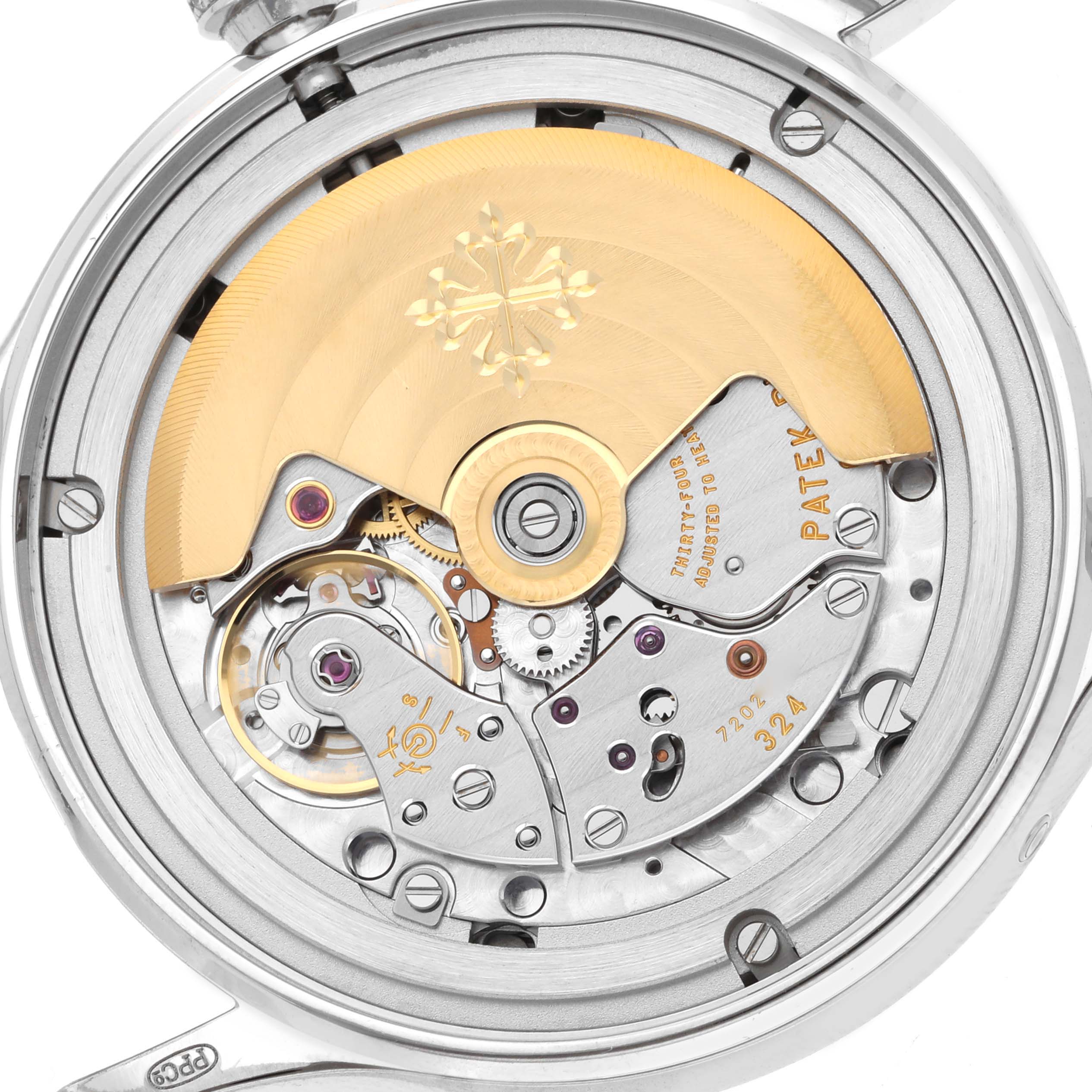 The image shows the back view of the Patek Philippe Complications 4947G-001 Men
s White Gold Blue Dial watch, highlighting the rotor and intricate movement components.