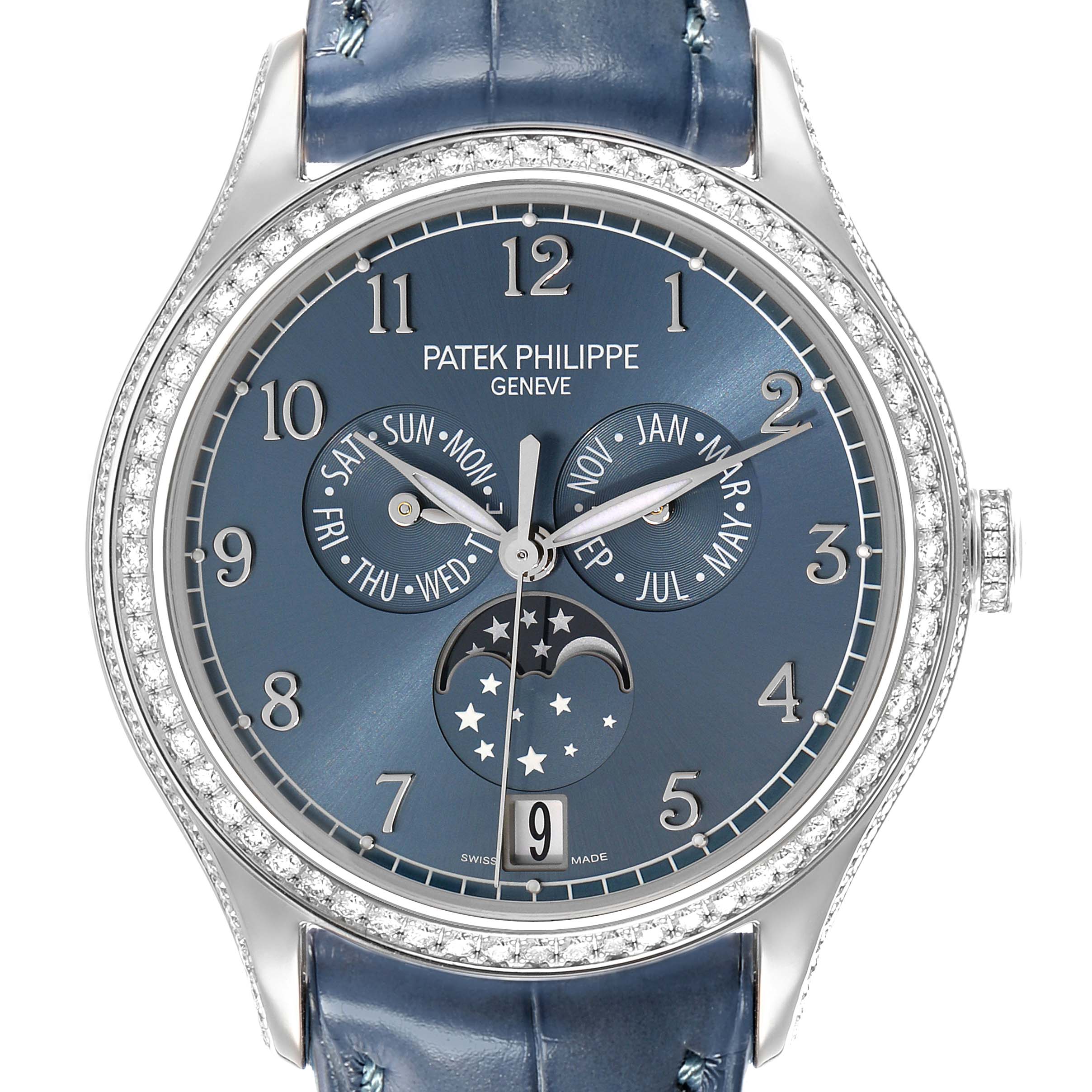 The Patek Philippe Complications 4947G-001 Men
s White Gold Blue Dial watch is shown from a front angle, displaying its dial with day, month, and moon phase indicators.