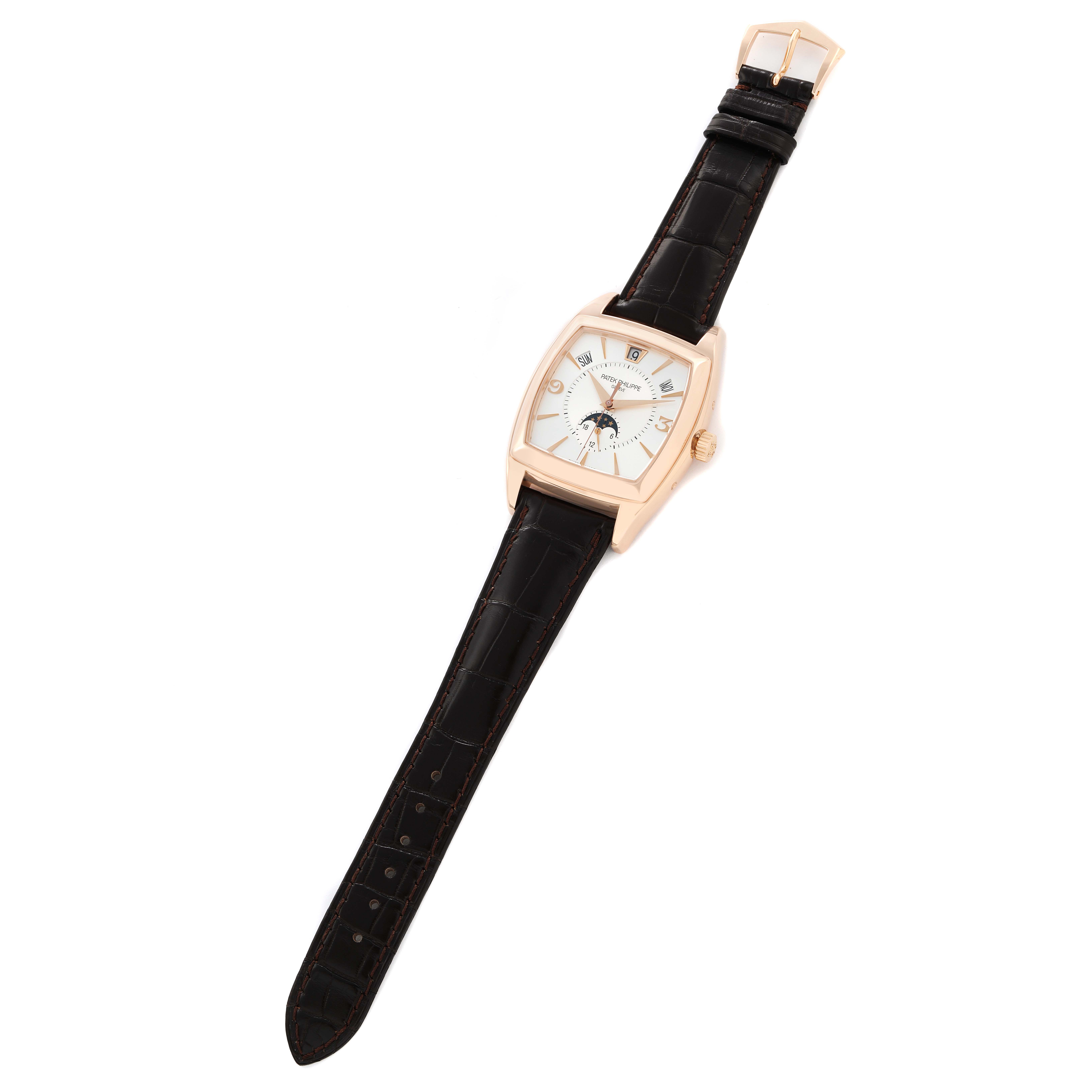 The Patek Philippe Gondolo 5135R-001 Men
s Rose Gold White Dial watch is shown from a top-down angle, displaying its face, strap, and buckle.