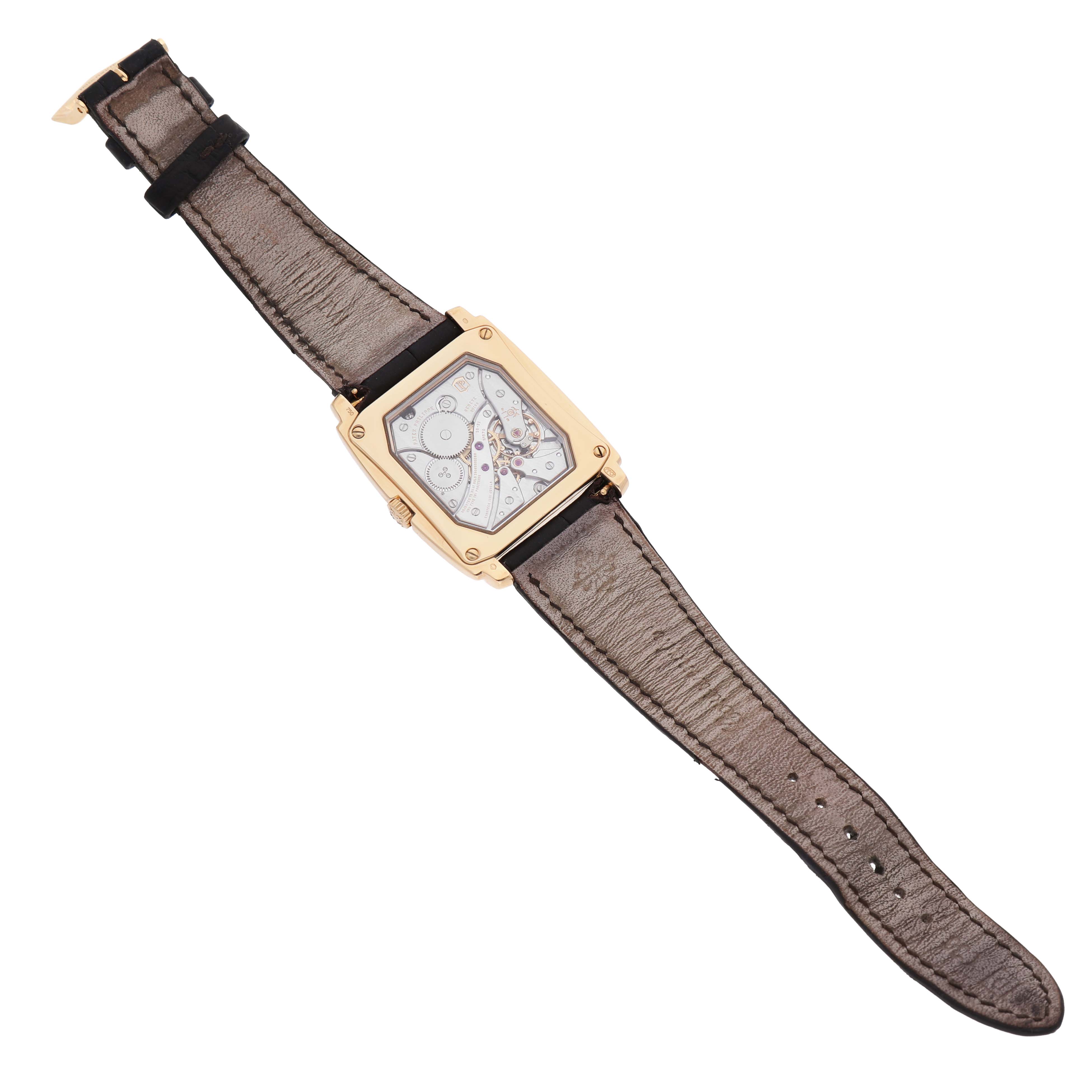 The Patek Philippe Gondolo 5124J-001 Men's Yellow Gold Silver Dial watch is shown from the back, displaying its movement and the strap fully extended.