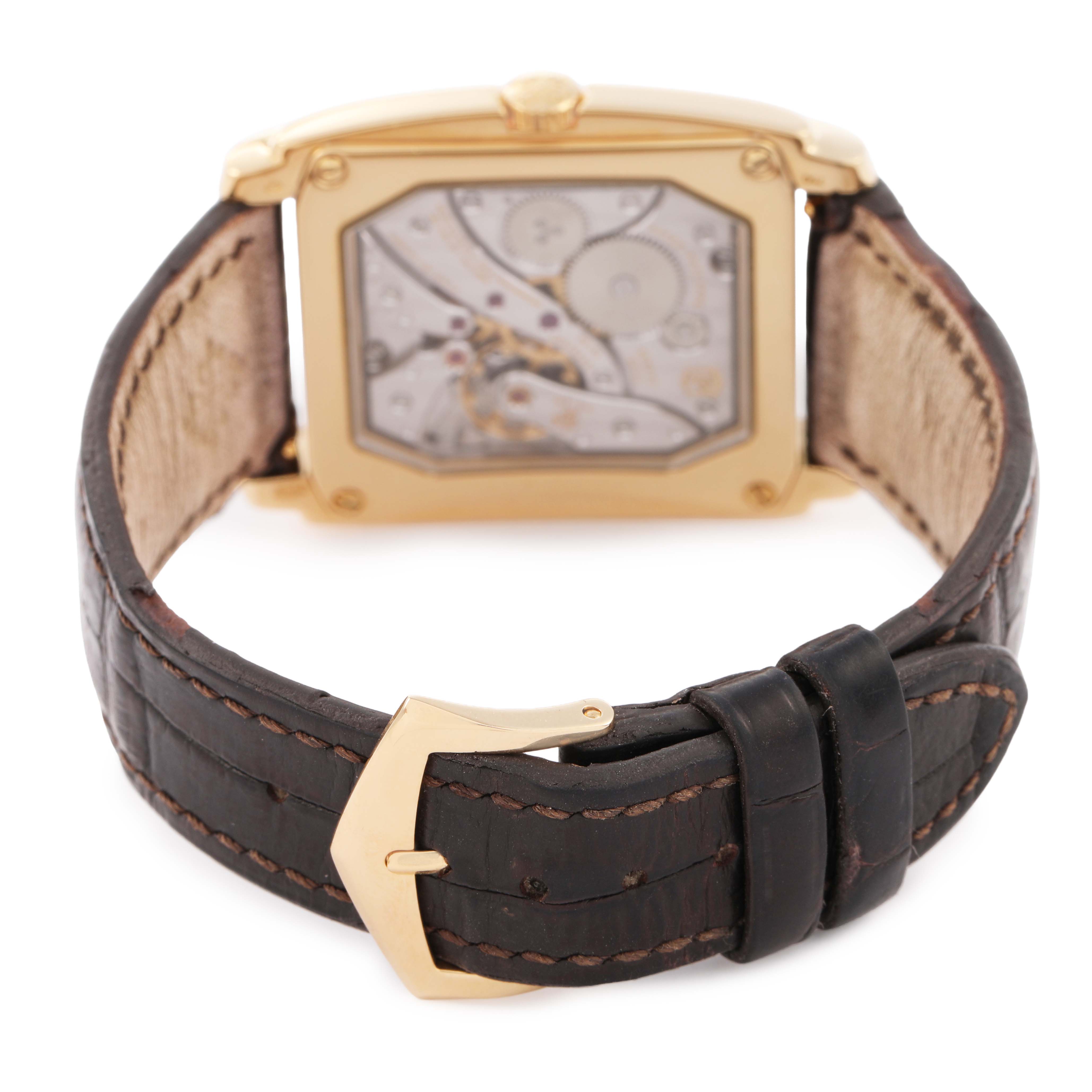 The image shows the back view of a Patek Philippe Gondolo 5124J-001 Men's Yellow Gold Silver Dial watch, highlighting the movement and clasp.