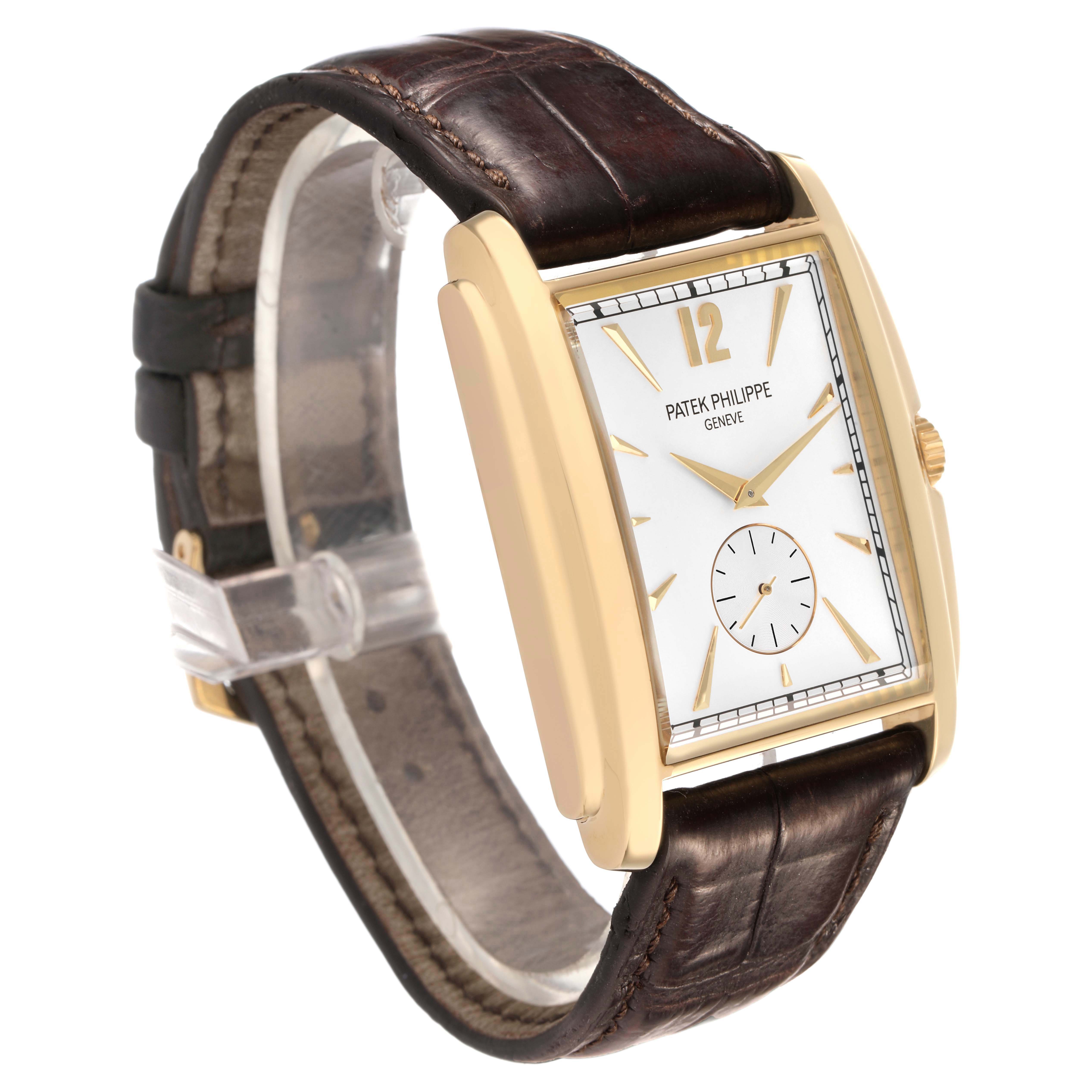 The Patek Philippe Gondolo 5124J-001 Men's Yellow Gold Silver Dial watch is shown at a three-quarter angle, highlighting the front, case, and leather strap.