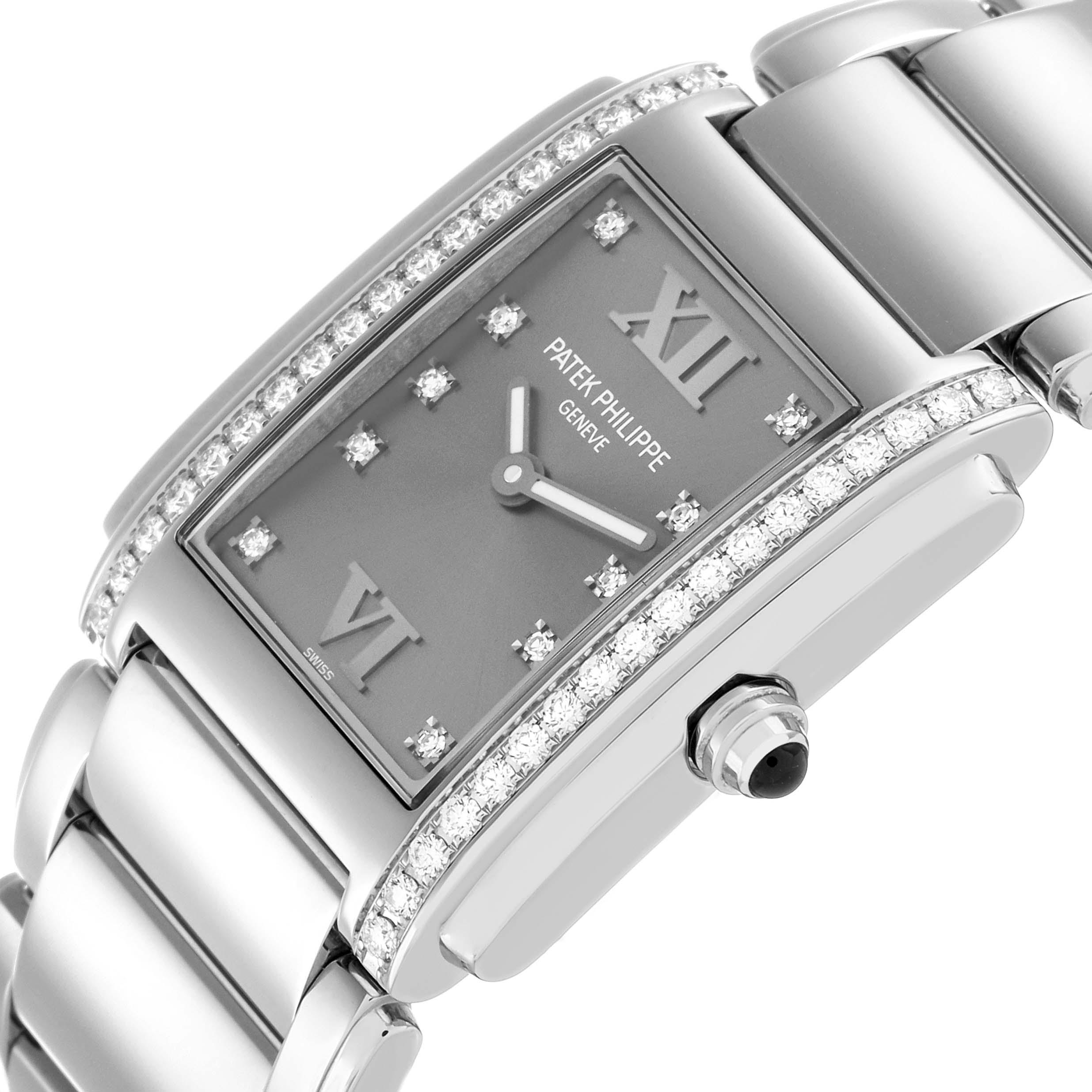 The Patek Philippe Twenty-4 4910/10A-010 Women's Stainless Steel Silver Dial watch is shown at an angled view, highlighting its diamond-encrusted bezel, dial, and bracelet.